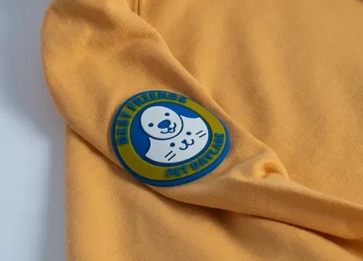 Close-up of a rubberized PVC-style badge applied to a branded uniform sleeve