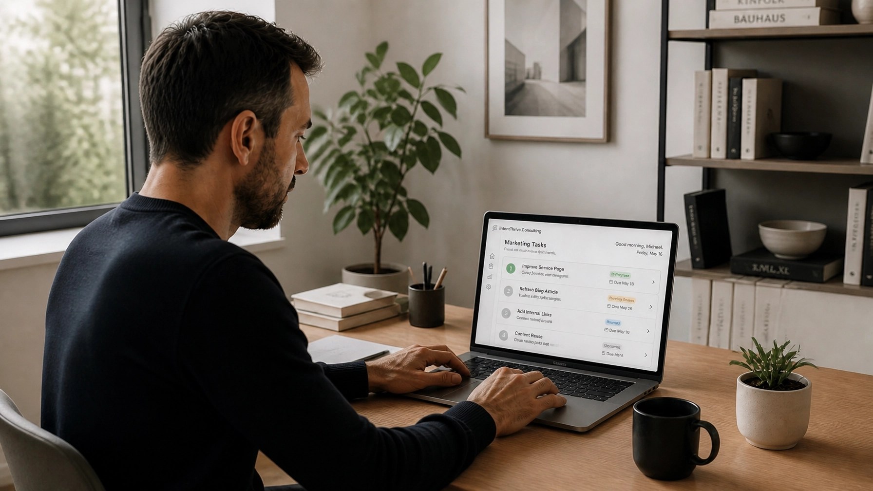 Focused professional in a minimalist workspace reviewing a laptop dashboard with soft natural light and neutral tones.