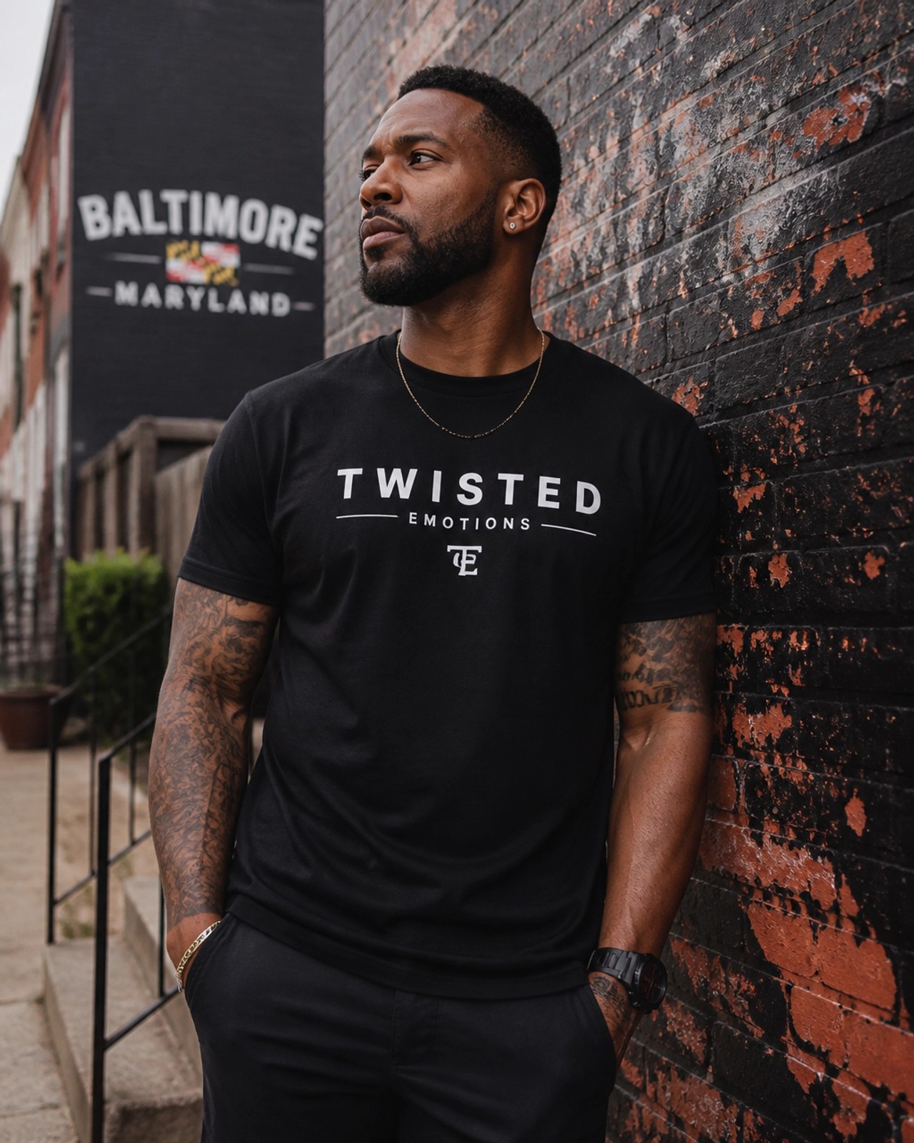A model wearing a Twisted Emotions t-shirt in an urban Maryland setting