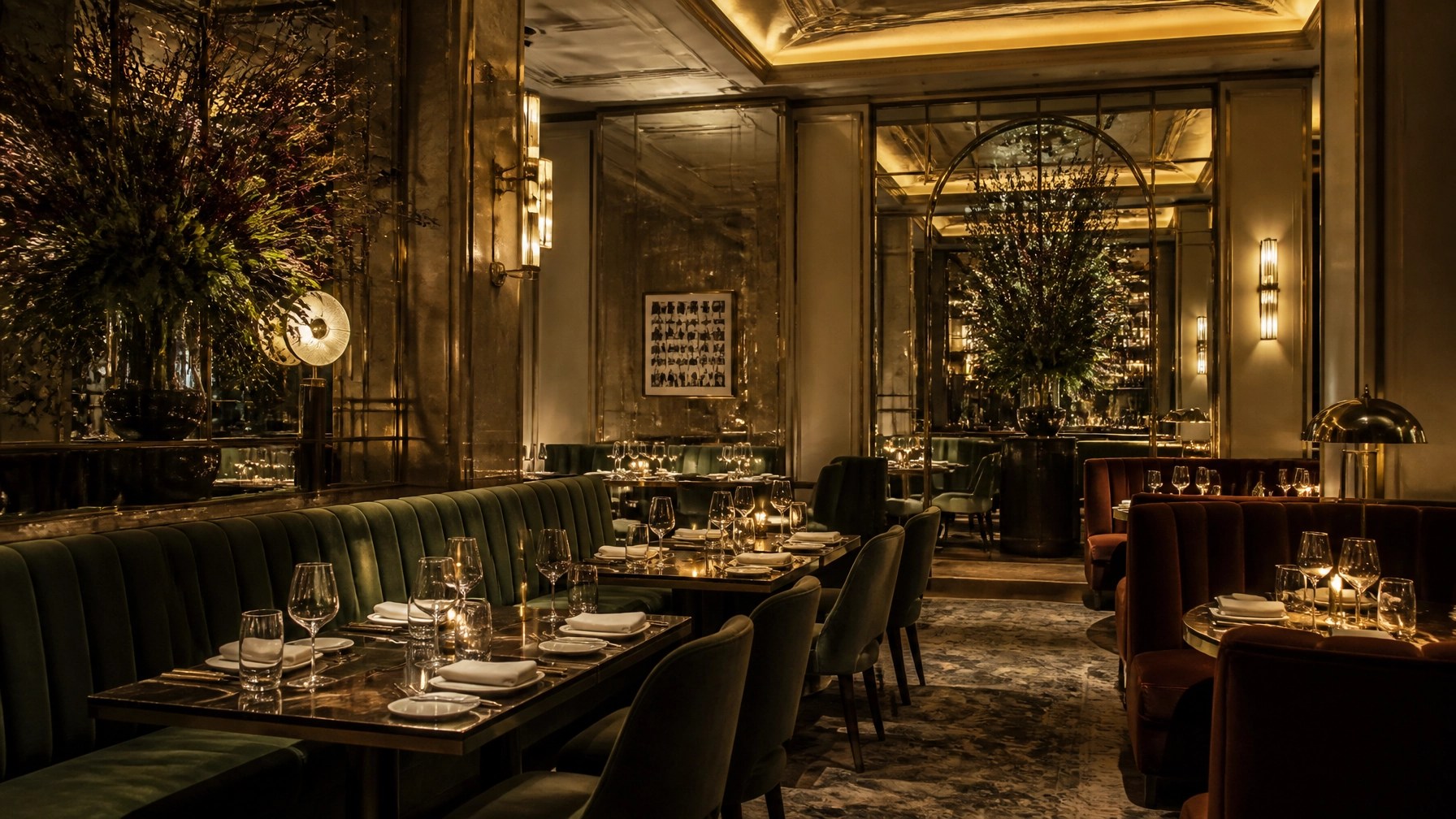 Upscale NYC restaurant interior with velvet banquettes and golden lighting