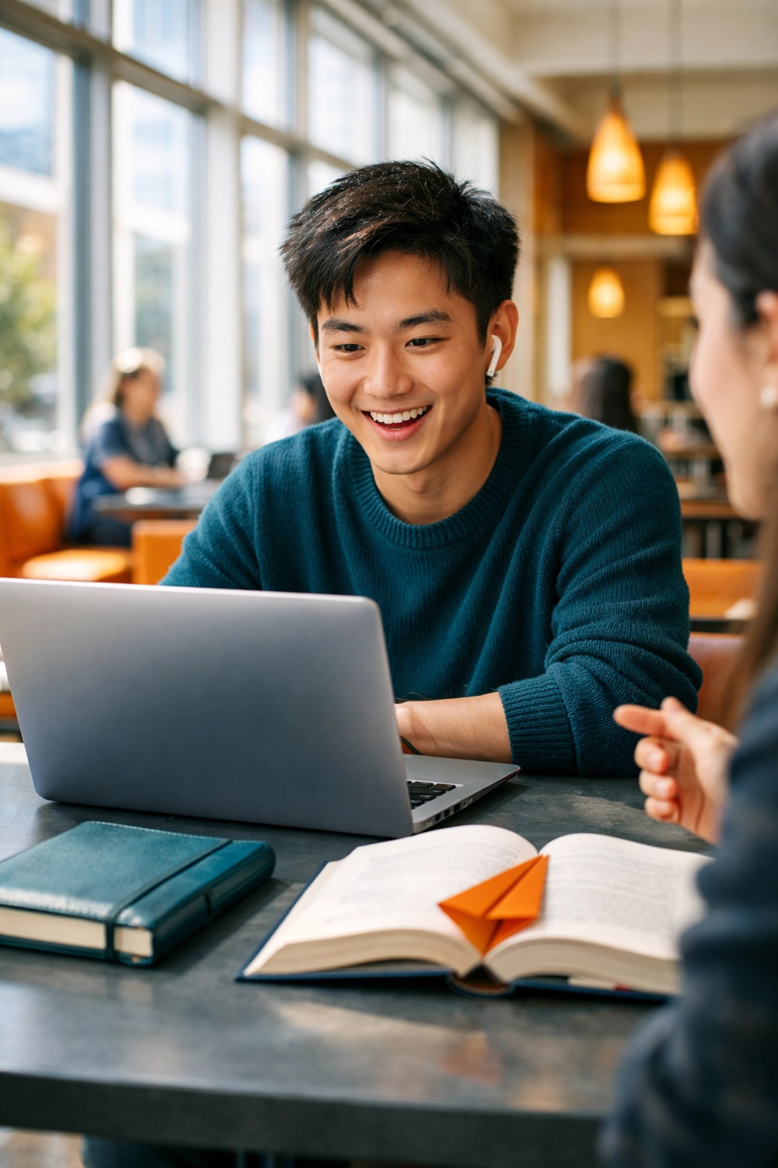 Diverse student studying in a sunlit café, using their education as a launchpad for career success.