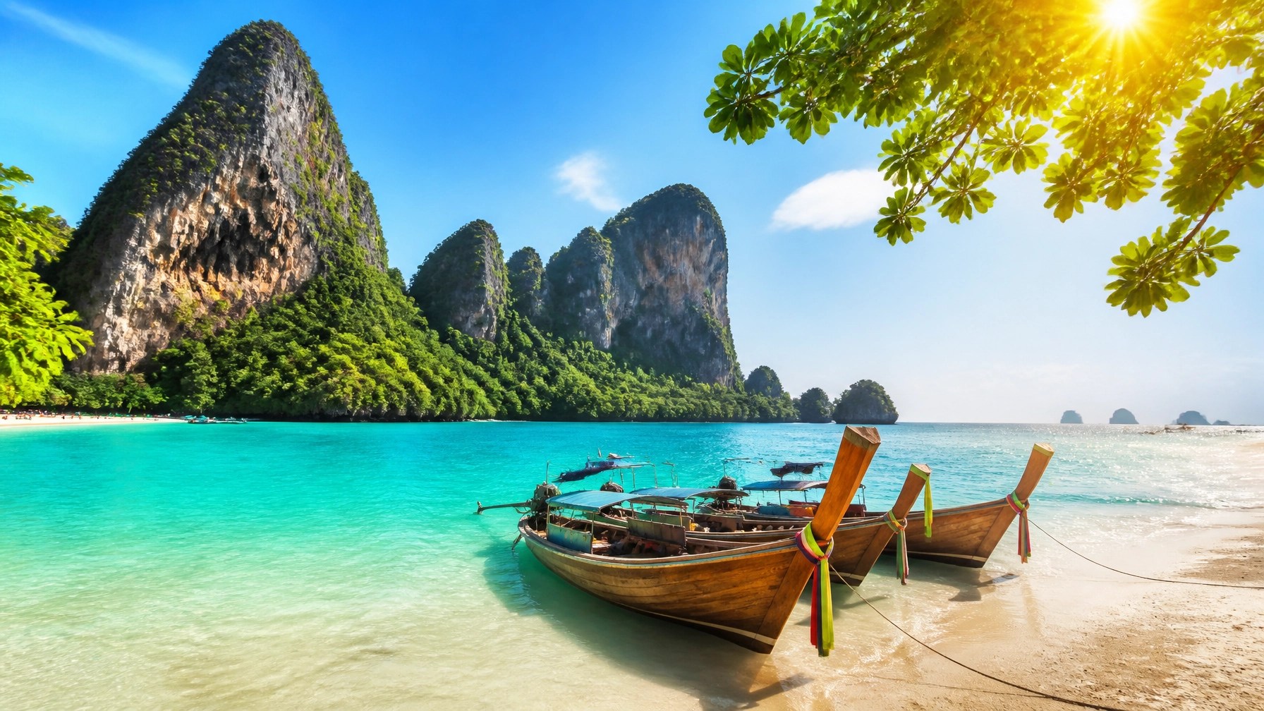 Lush tropical beach in Thailand with limestone karsts and crystal clear water