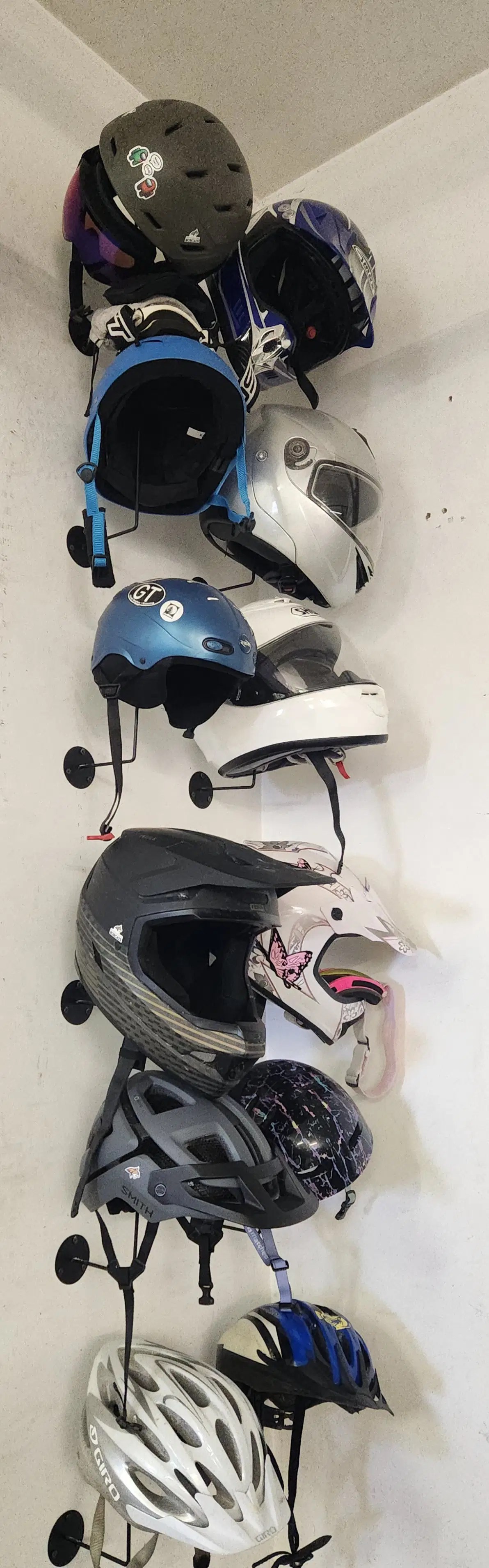 Real-life helmet storage showing seasonal helmet rotation