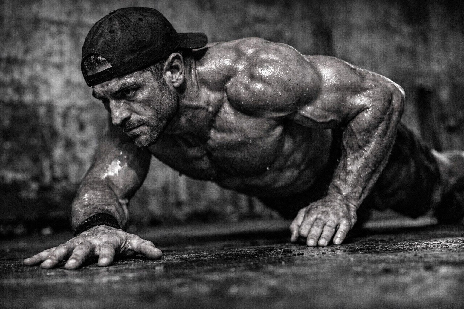 Athlete Tibs Parise performing a staggered hand push-up to improve chest symmetry and upper body stability.