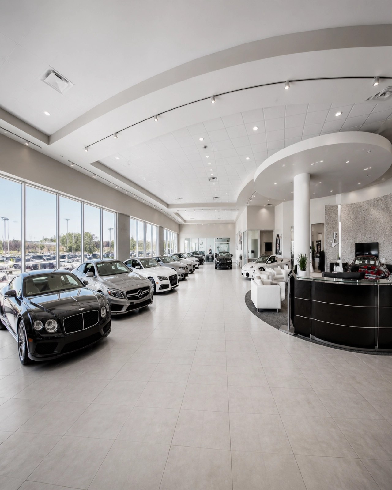 A wide-angle, architectural photography shot of a finished commercial lobby, rendered in clean whites and grayscale with deep perspective.