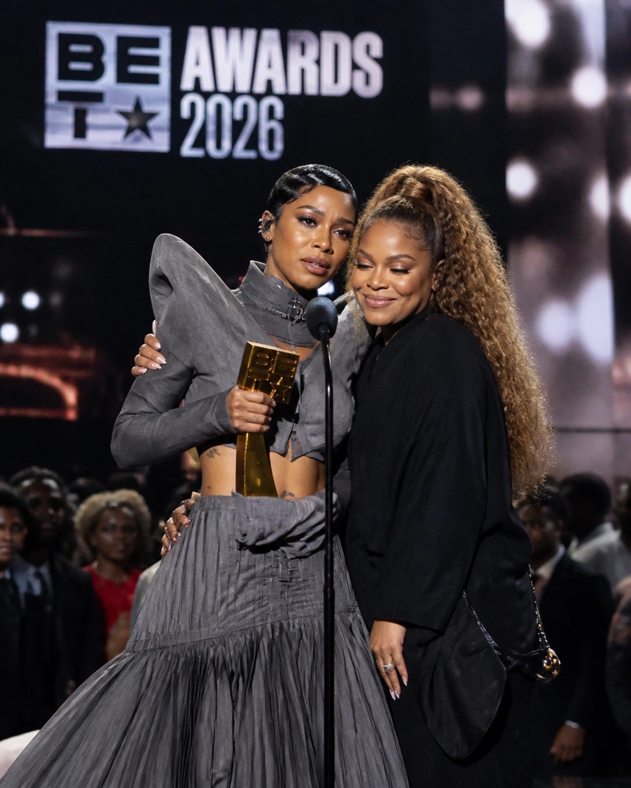 Teyana Taylor accepting the Icon of the Year Award from Janet Jackson