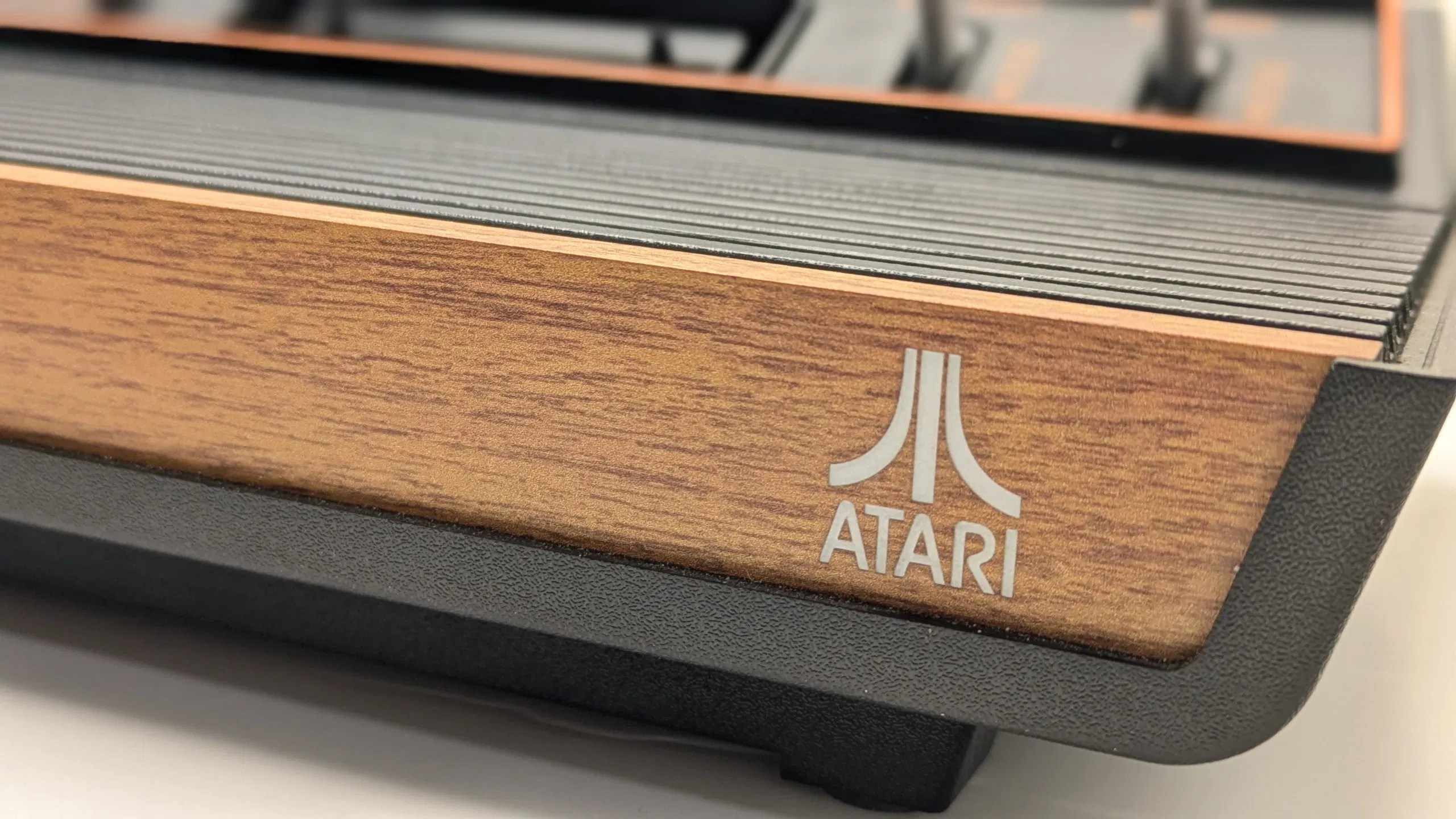 Close-up of an original Atari game console with faux wood grain
