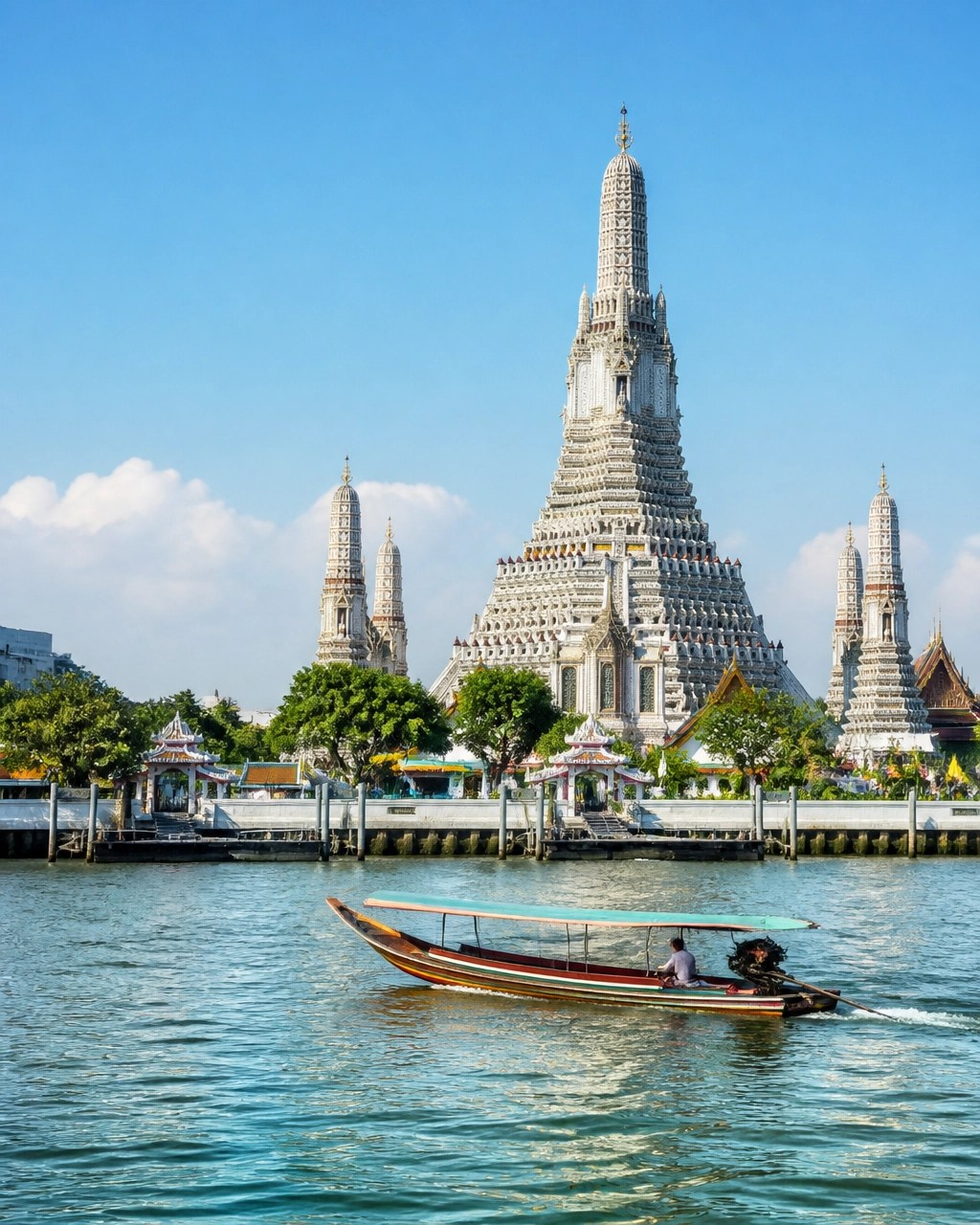 Wat Arun beside the Chao Phraya River in bright daytime light