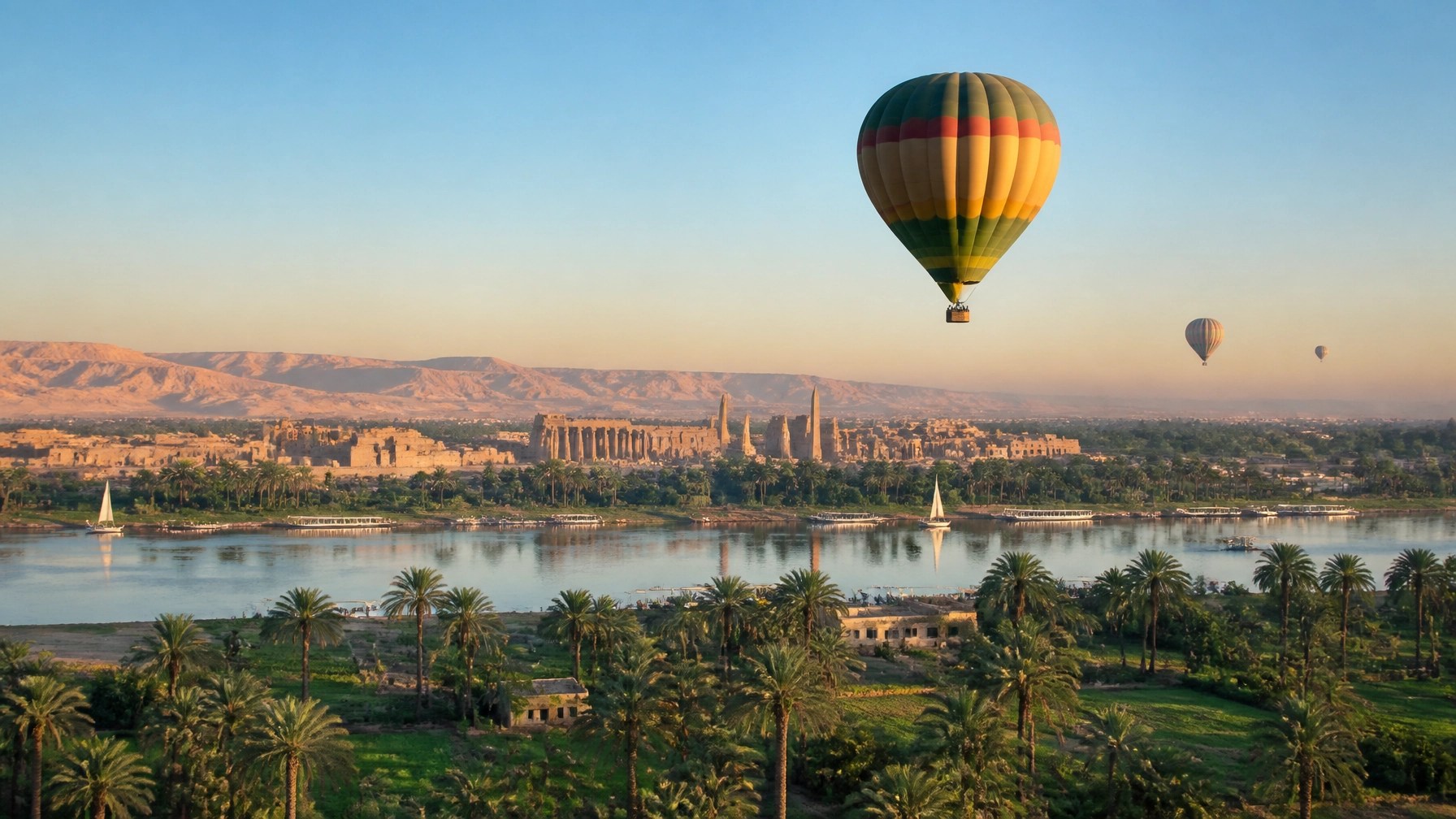 Hot-air balloon rising above the Nile Valley near Luxor in bright morning light