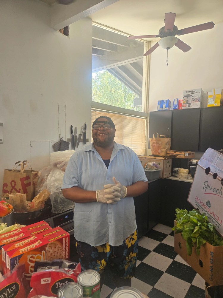 A CityHeART volunteer organizing food and supplies for HeARTy Foods