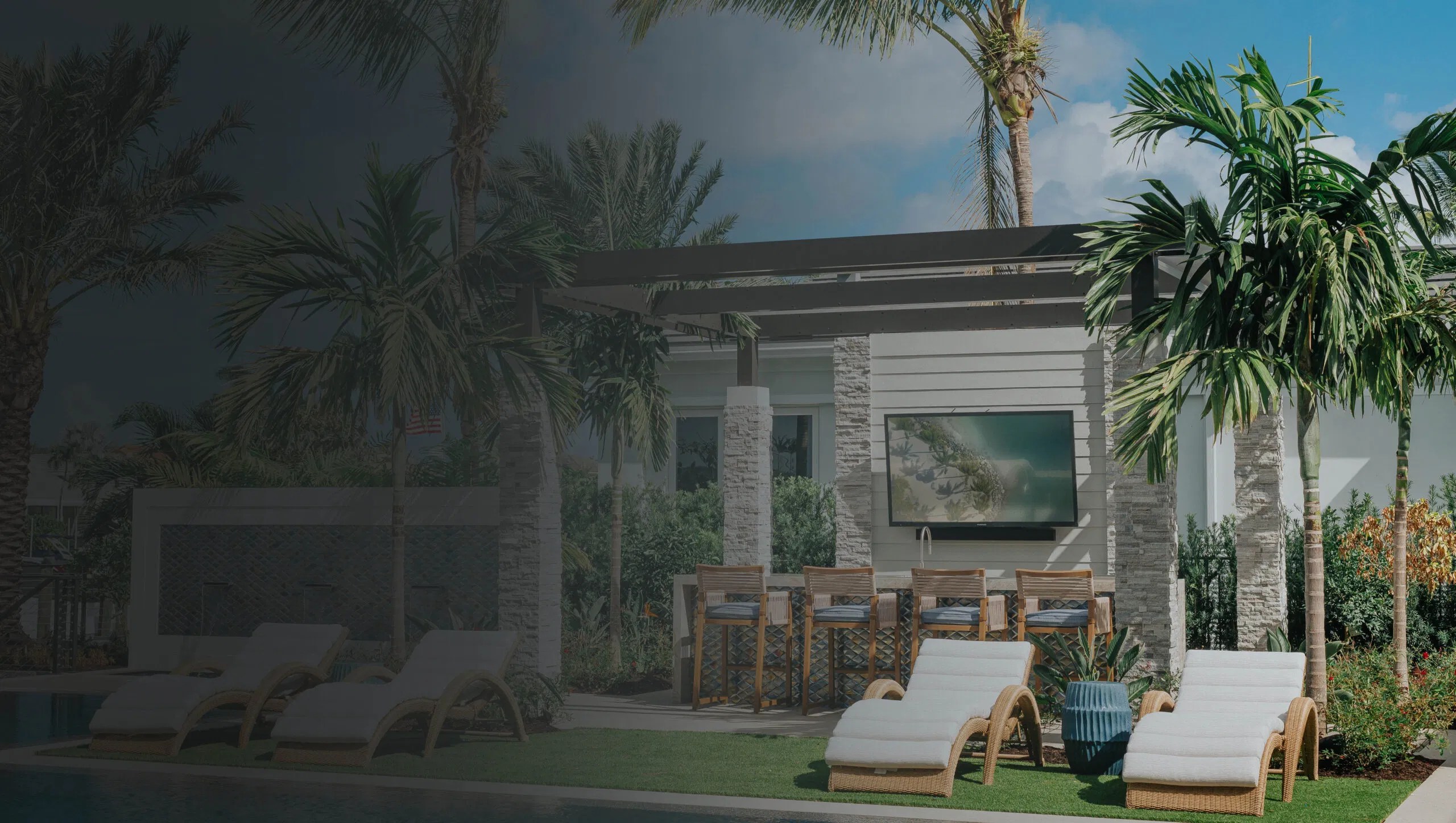 Modern backyard space featuring a motorized louvered roof pergola with bar seating and poolside loungers, creating a polished South Florida setting for family gatherings, outdoor dining, and effortless entertaining by the pool.
