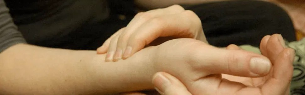 Close-up of a practitioner performing an Ayurvedic pulse diagnosis