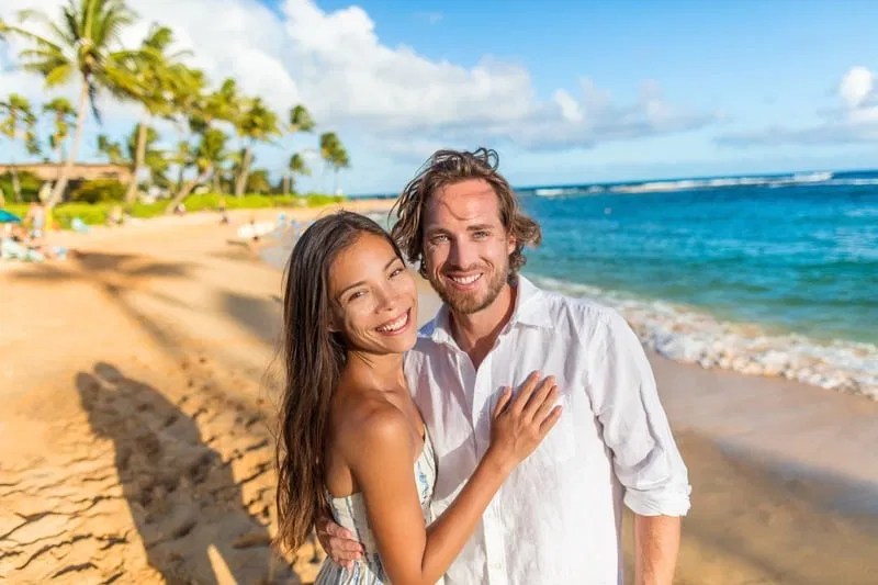 Joyful couple on a beach representing soul-aligned love and fulfilled relationship
