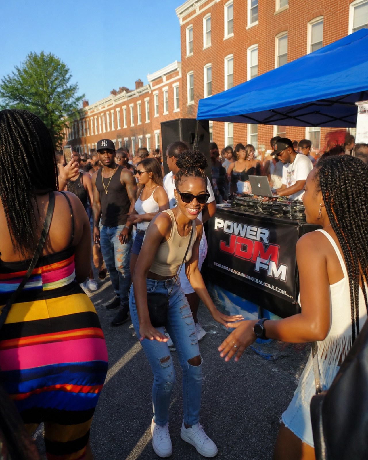 A vibrant summer block party in Baltimore where local fans gather to celebrate and vibe to the latest urban hits dominating the airwaves.