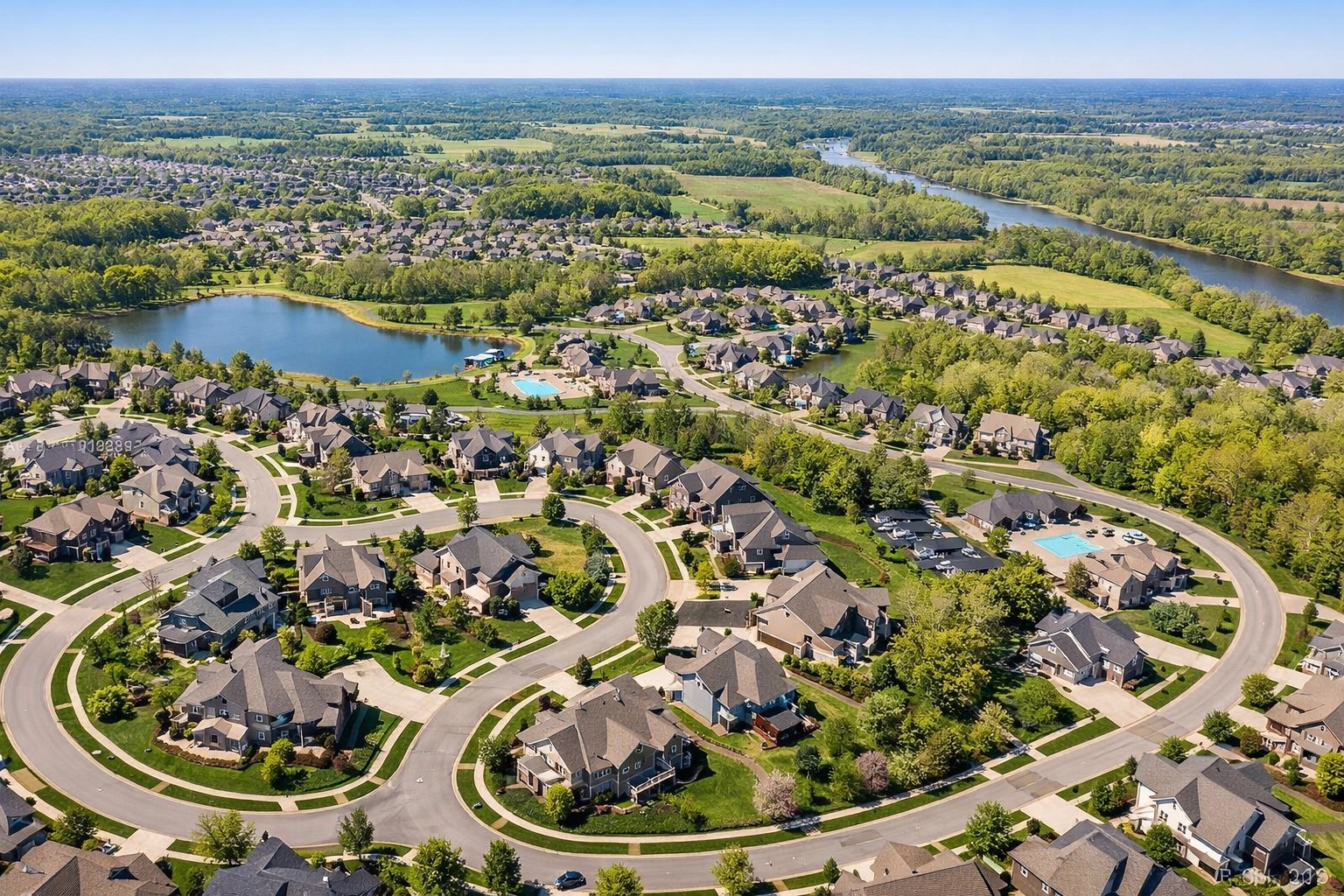 Aerial view of modern suburban neighborhoods and parks across Montgomery and Greene County, Ohio.