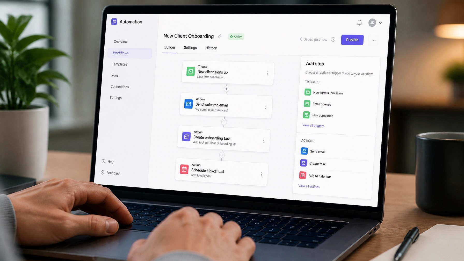 A person setting up an automated workflow on a laptop