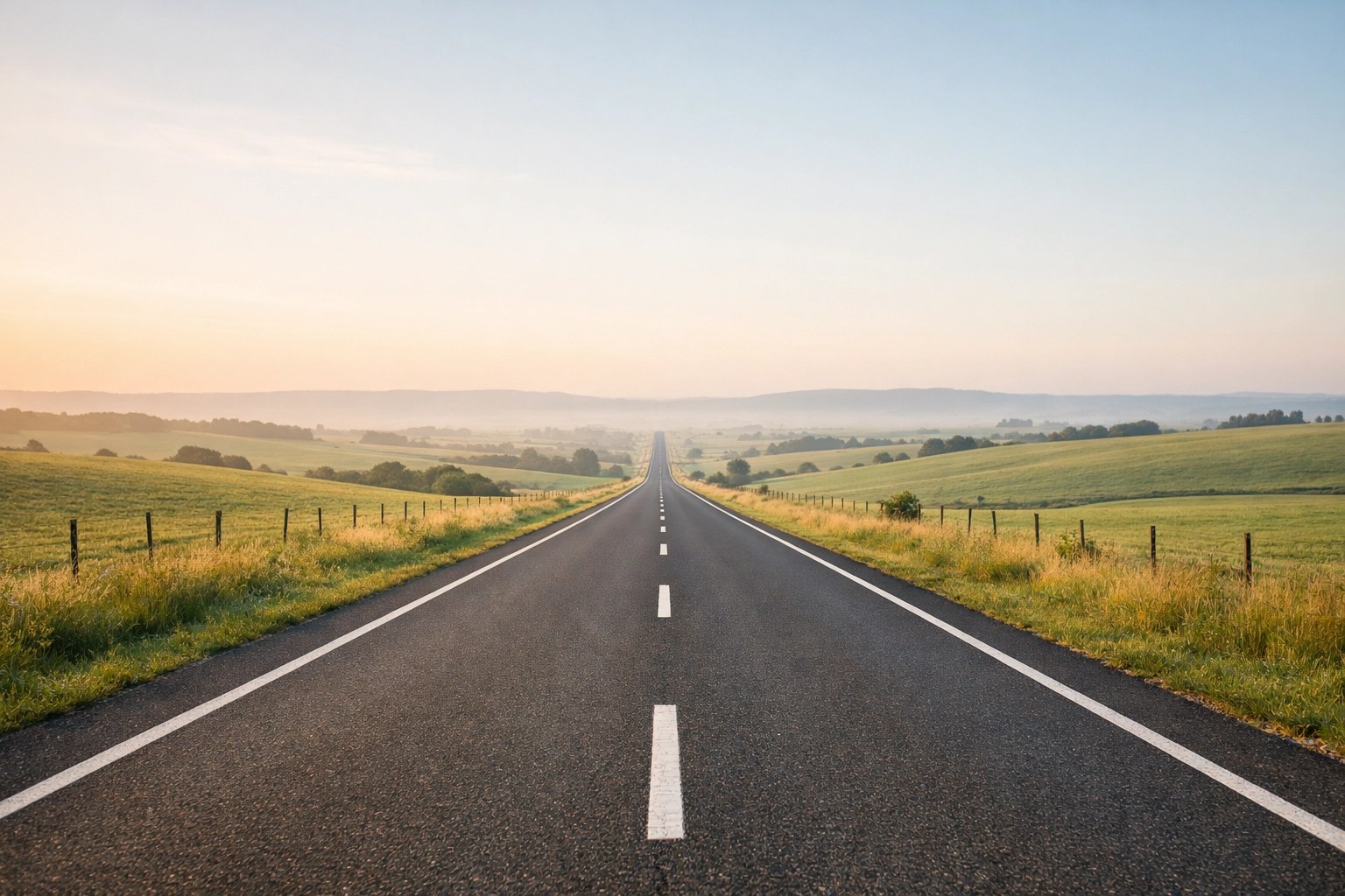 Long rural road stretching toward the horizon, symbolizing distance barriers to remote healthcare access.