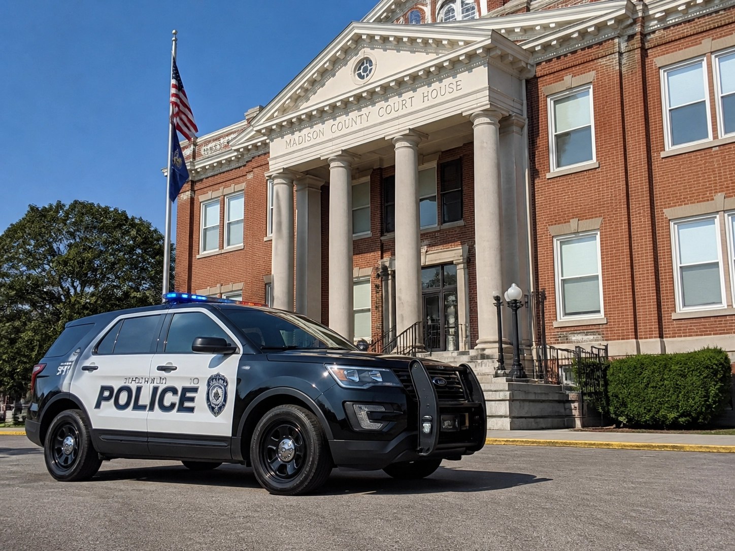 Local Kentucky police car at a municipal courthouse, representing boots-on-the-ground public safety IT support.