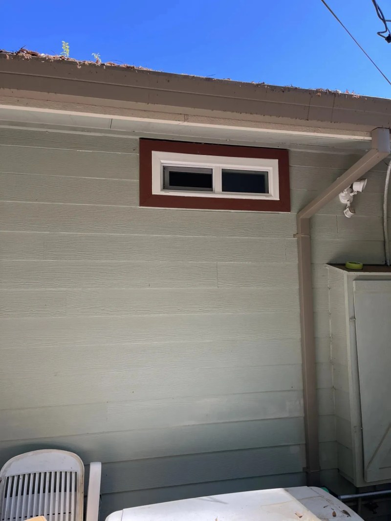 Residential transom window installed with clean exterior trim
