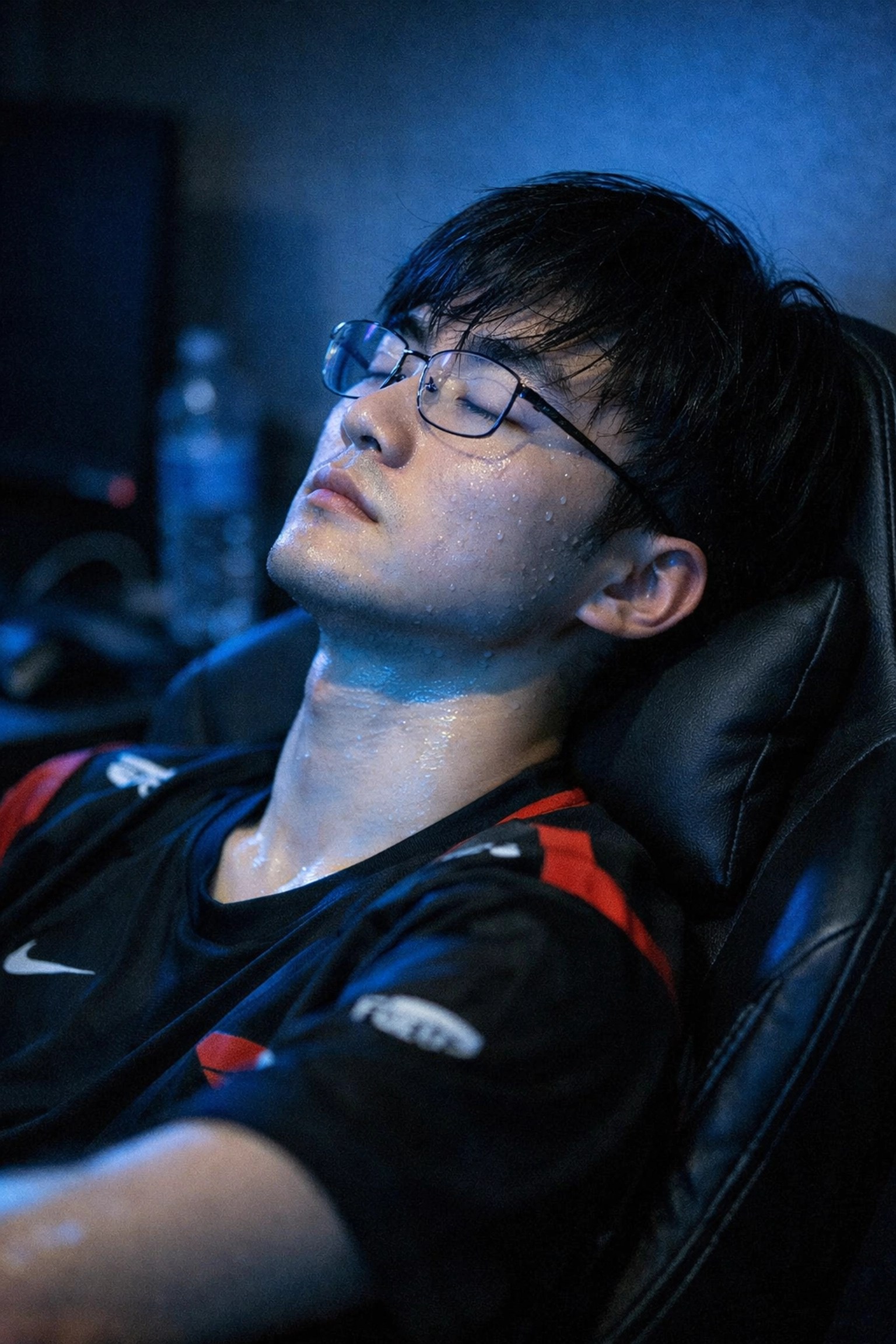 Exhausted professional gamer taking a recovery break after intense cognitive work.