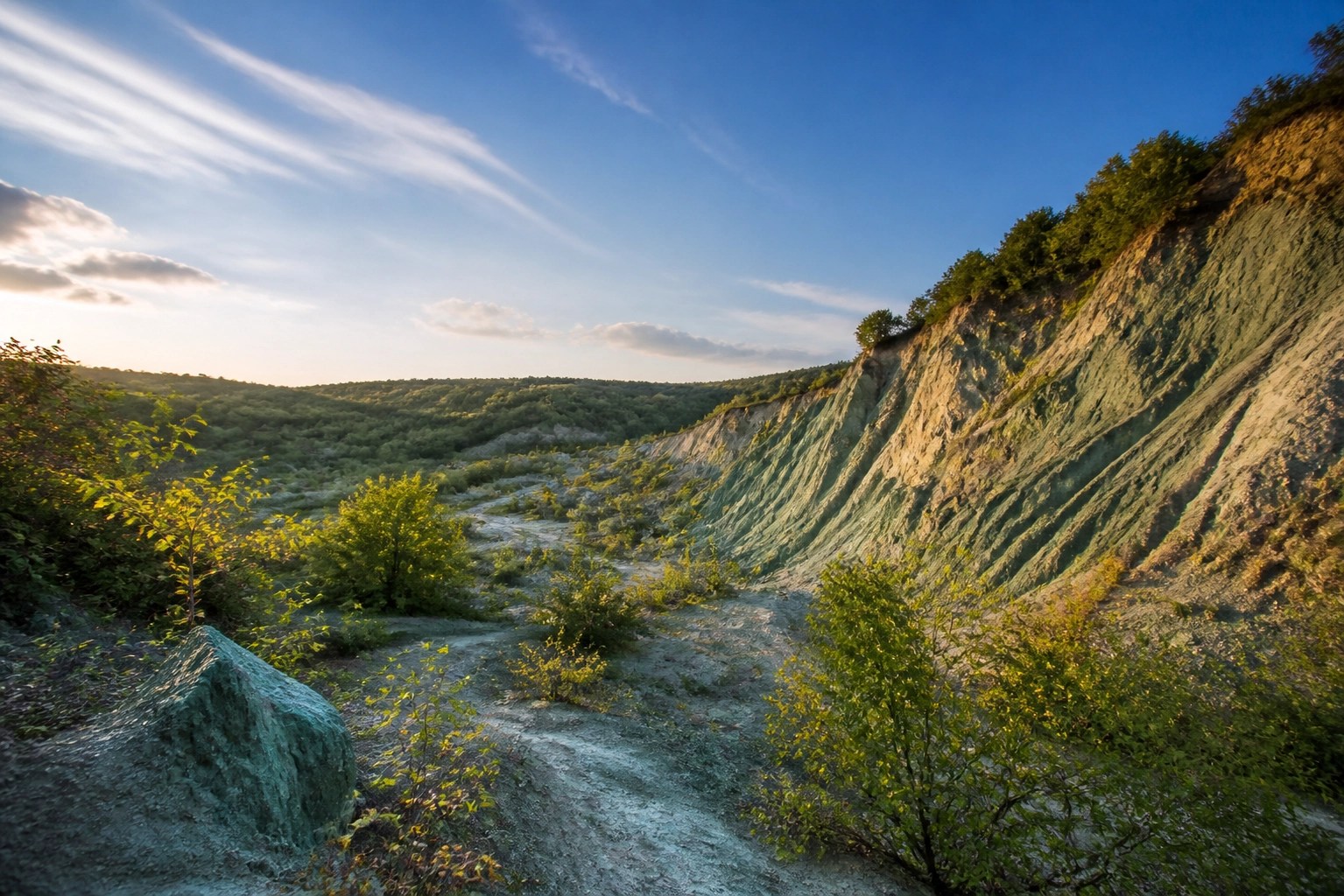A pristine natural green clay quarry in France showing the pure mineral source used for healing clay detox.