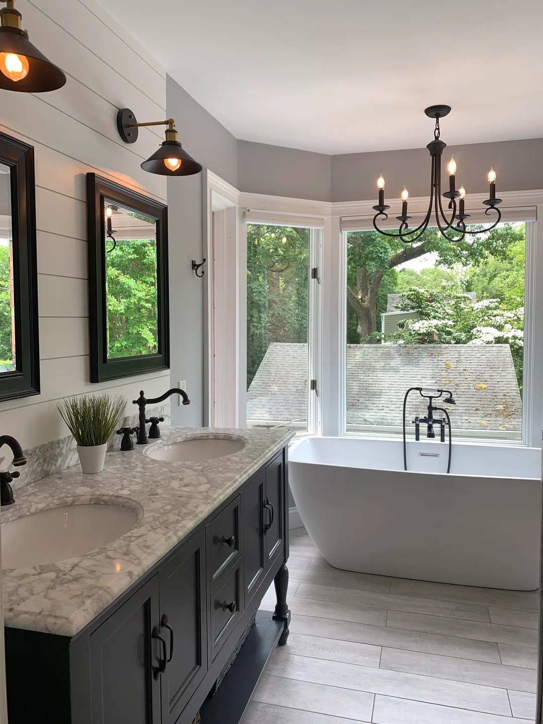 Elegant bathroom renovation featuring high-end lighting