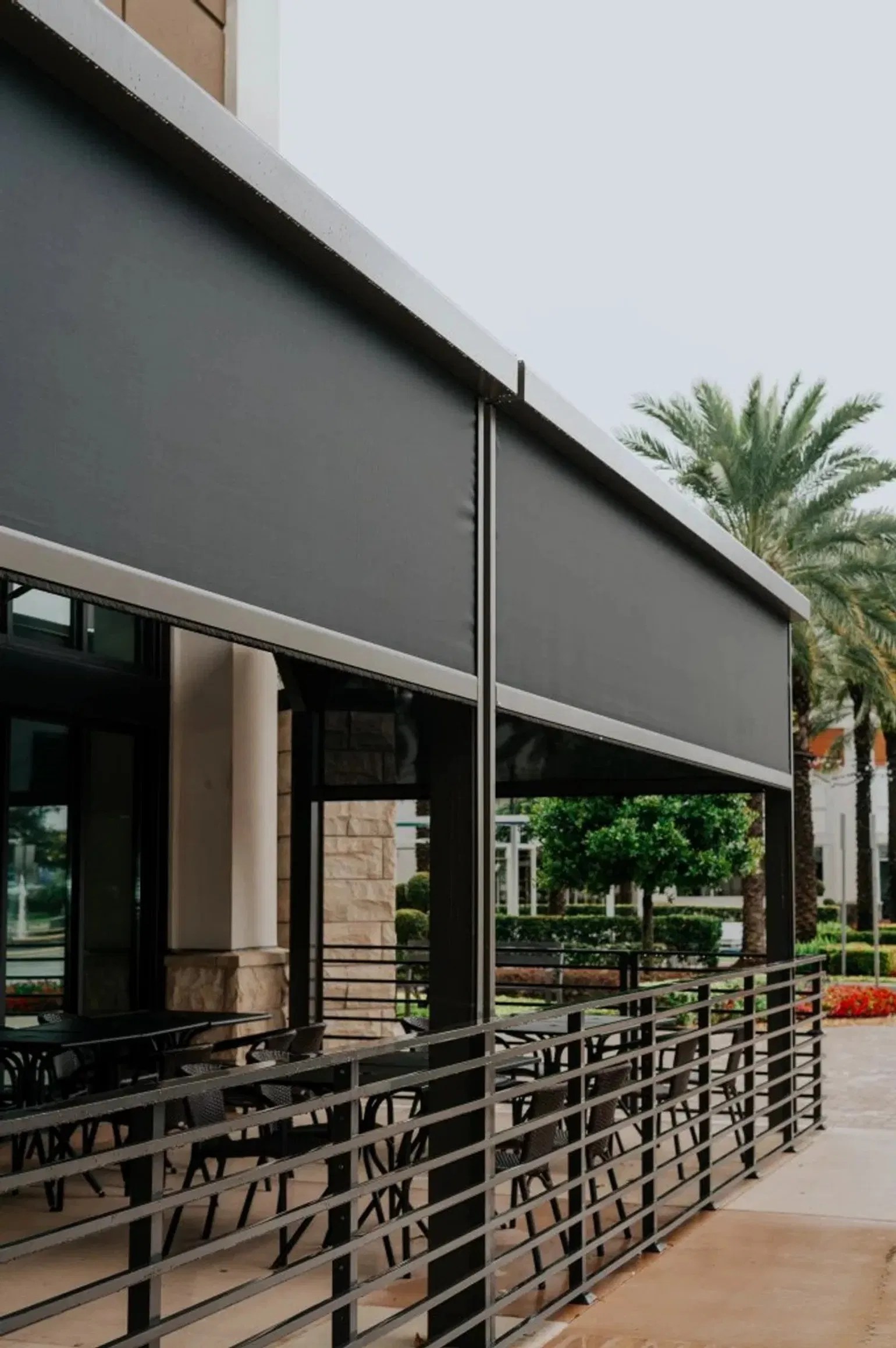 Retractable patio screen system providing privacy and sun control for an outdoor dining area