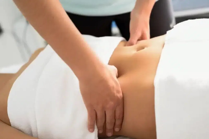 Therapist performing manual lymphatic drainage in a clinical setting