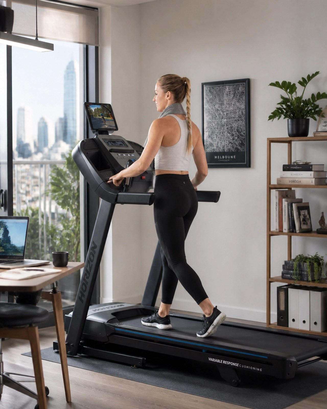 Professional working from home with treadmill nearby