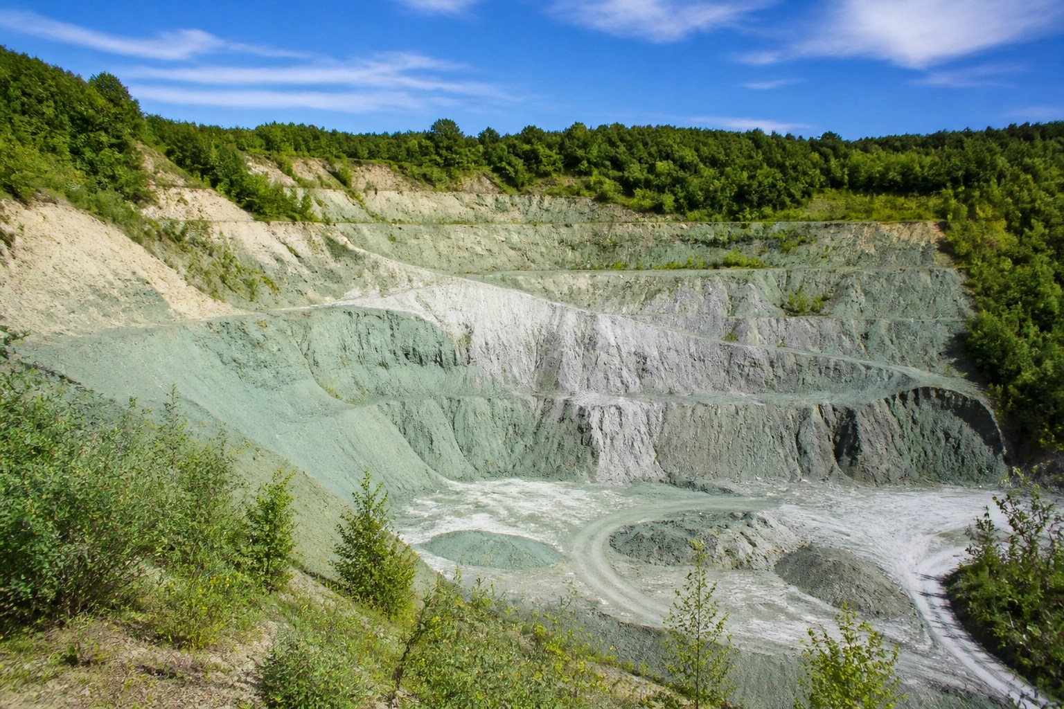 Pristine French green clay quarry showing natural mineral layers for non-toxic detox products.