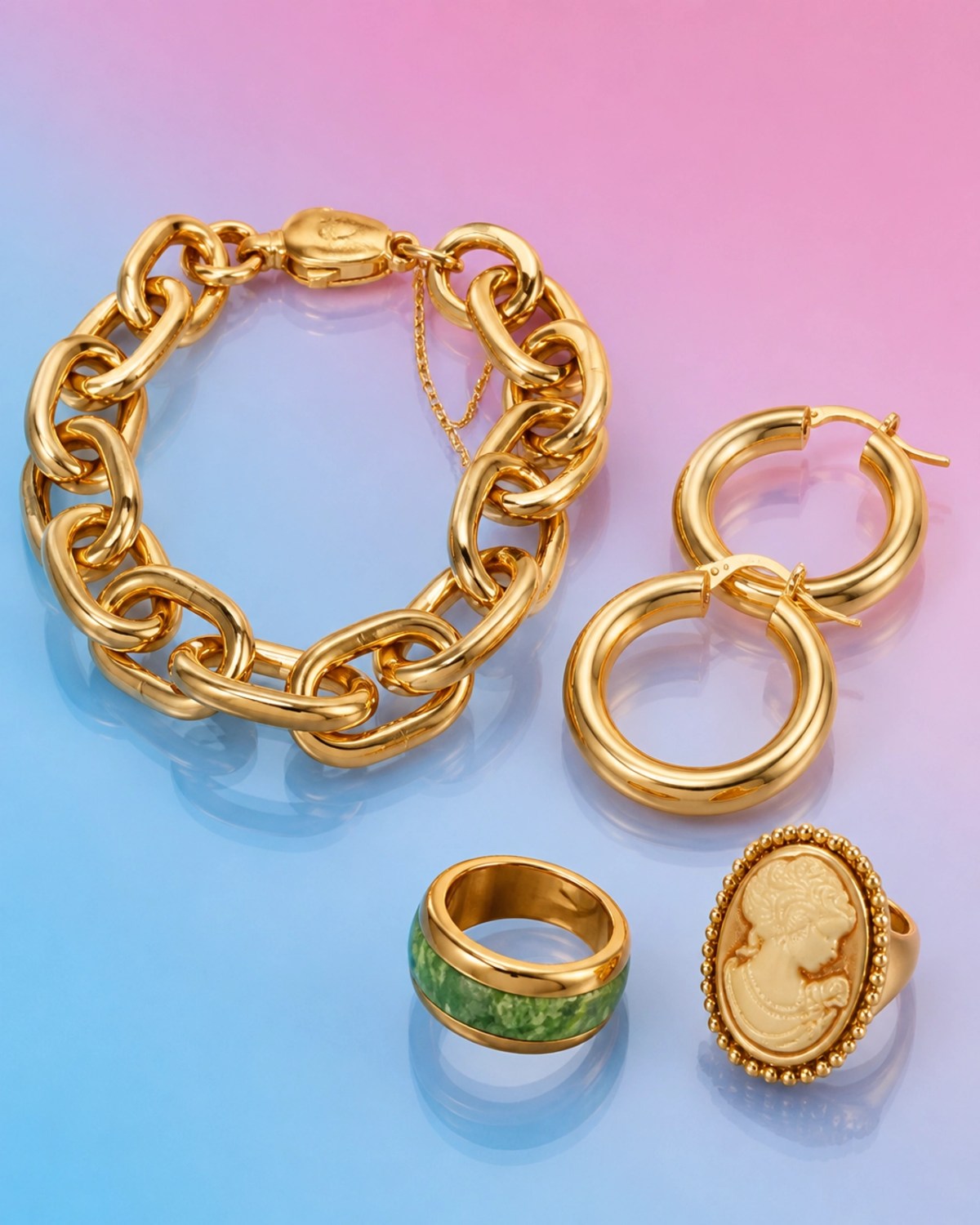 A collection of bold 1980s style yellow gold jewelry on a bright pastel gradient background.