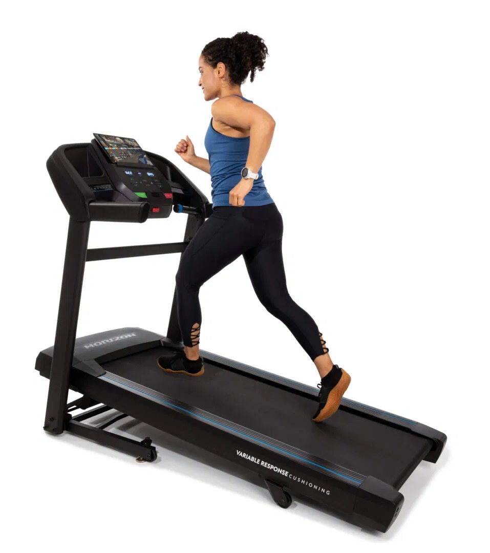 Woman jogging on a Horizon treadmill with variable response cushioning
