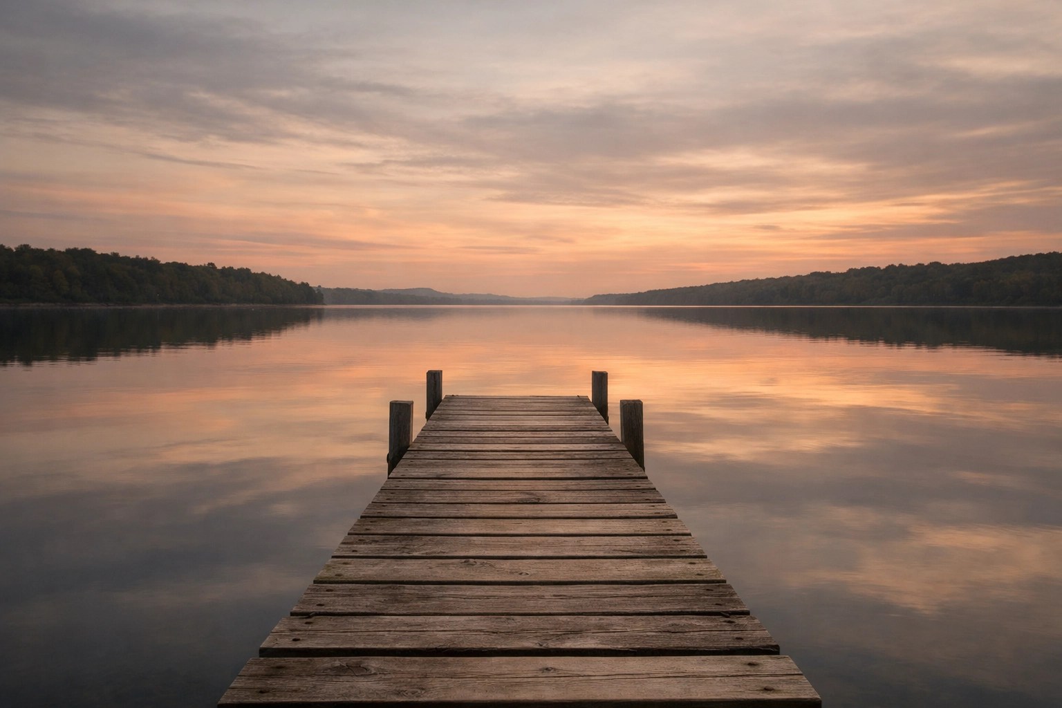 Serene sunset over a calm lake reflecting financial stability against market volatility.
