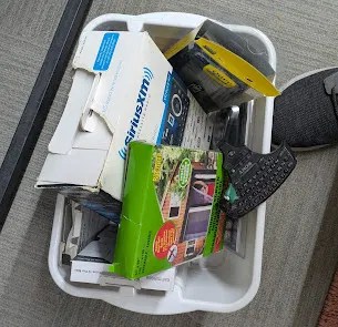 A bin filled with assorted discarded electronics ready for recycling