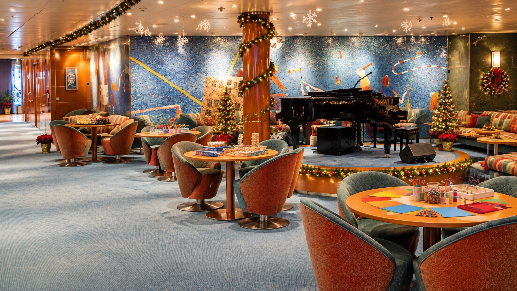 Empty holiday-decorated cruise ship youth club and teen lounge with activity tables and warm lighting