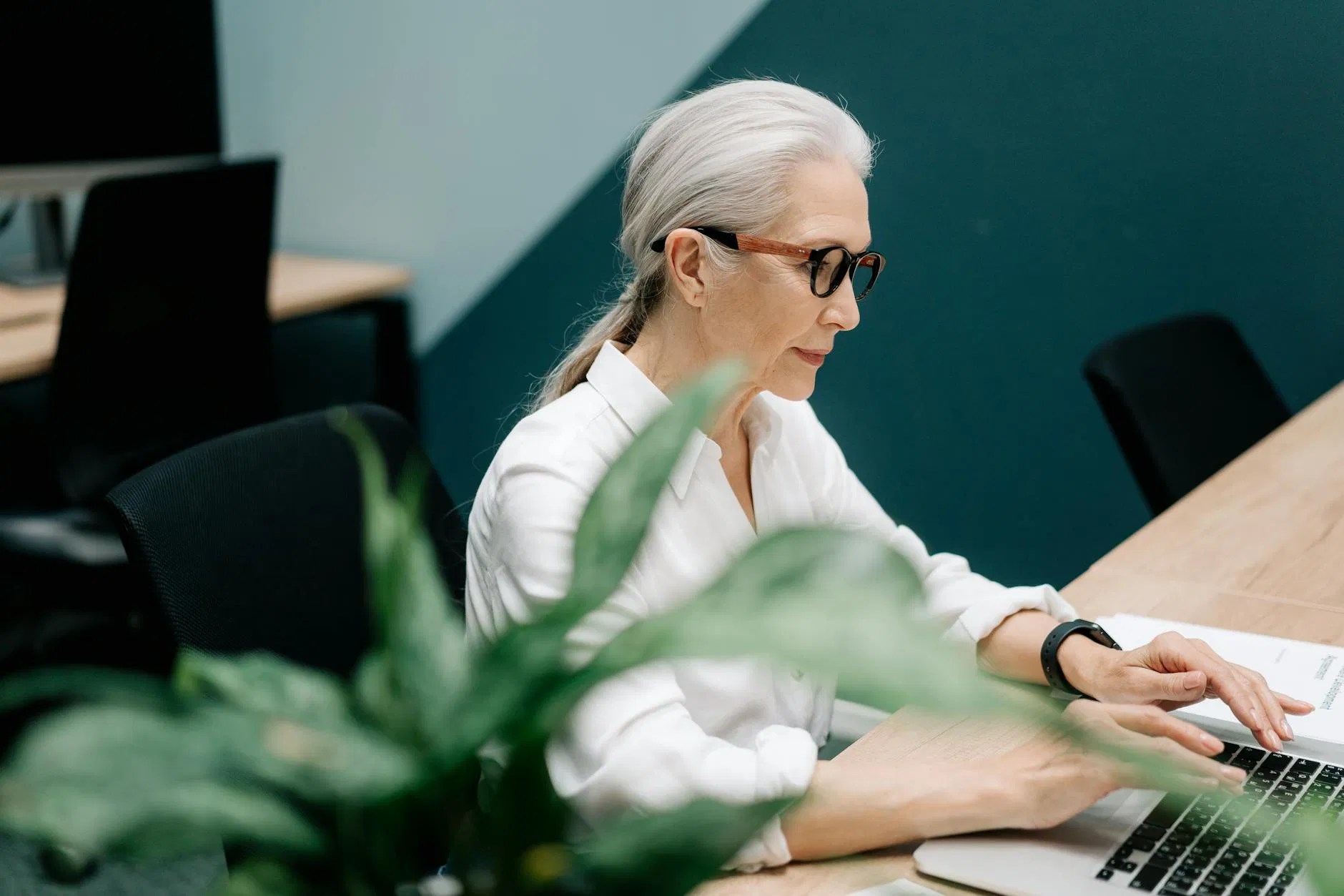 Focused professional reviewing payroll documents and compliance records