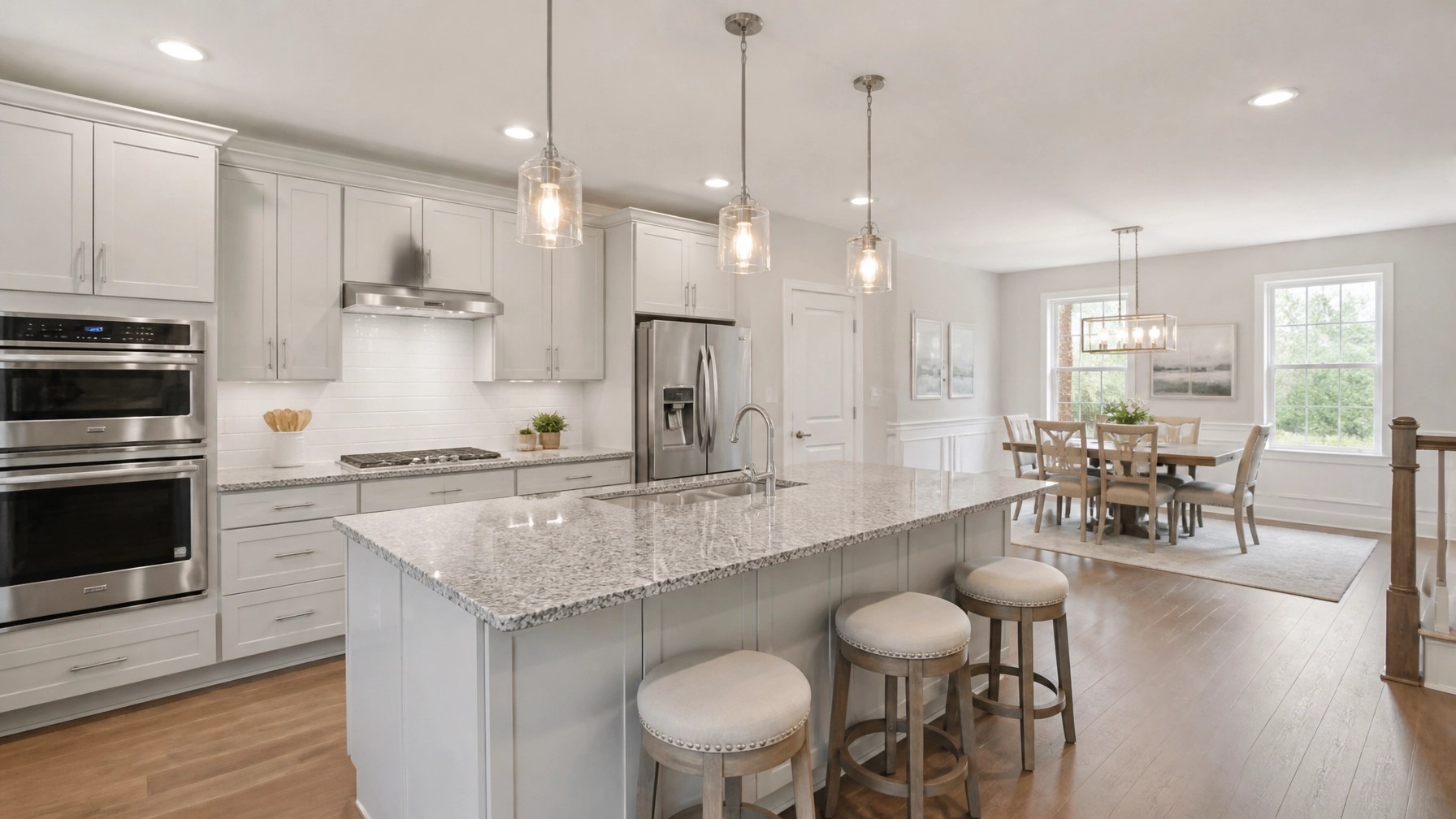 A modern, professionally staged kitchen and dining area in a Maryland home with neutral colors, granite countertops, and updated lighting. The space is clean and bright to show maximum ROI for a home sale.