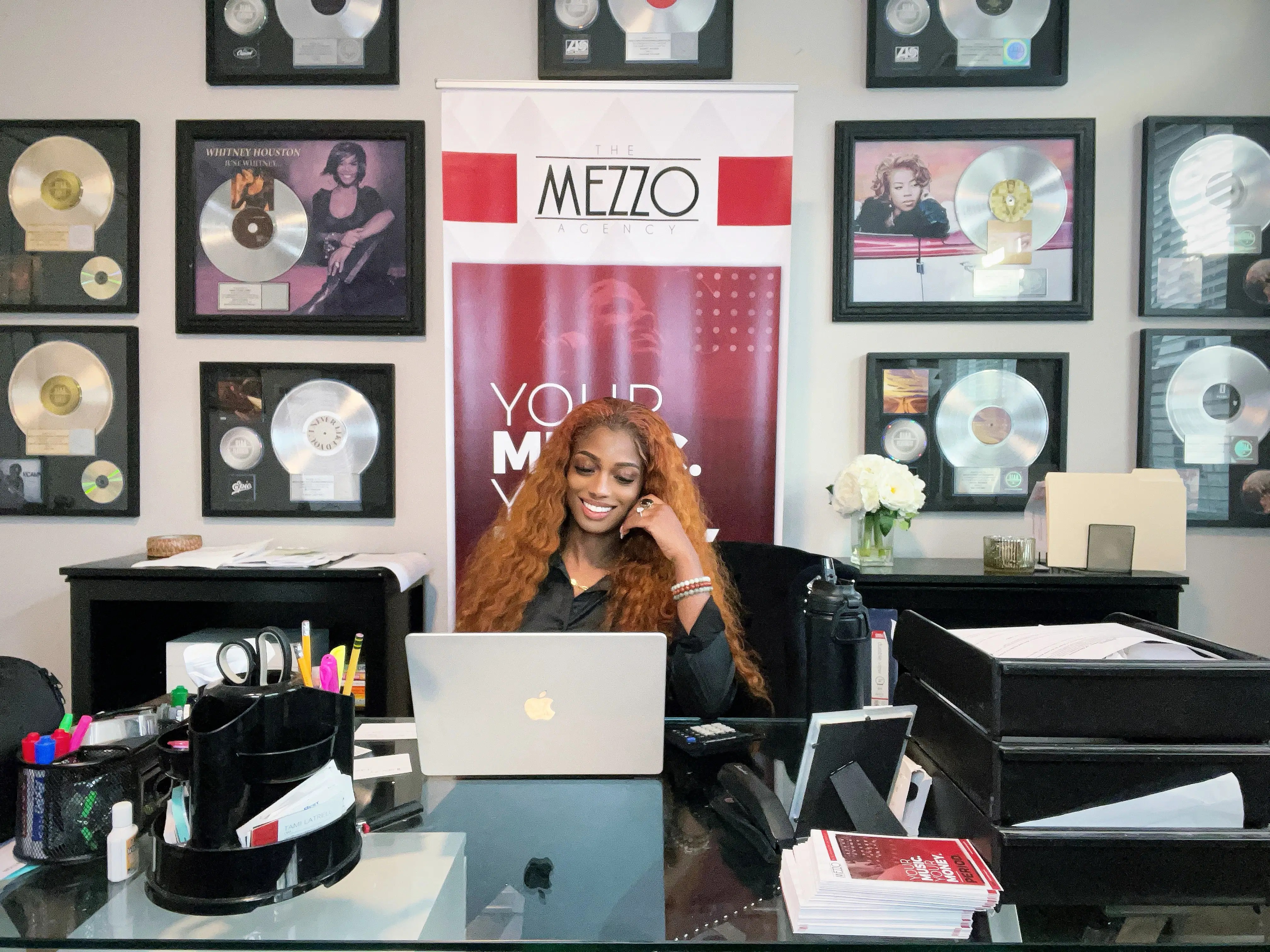 Music professional working in an organized office with music industry records and catalog documents