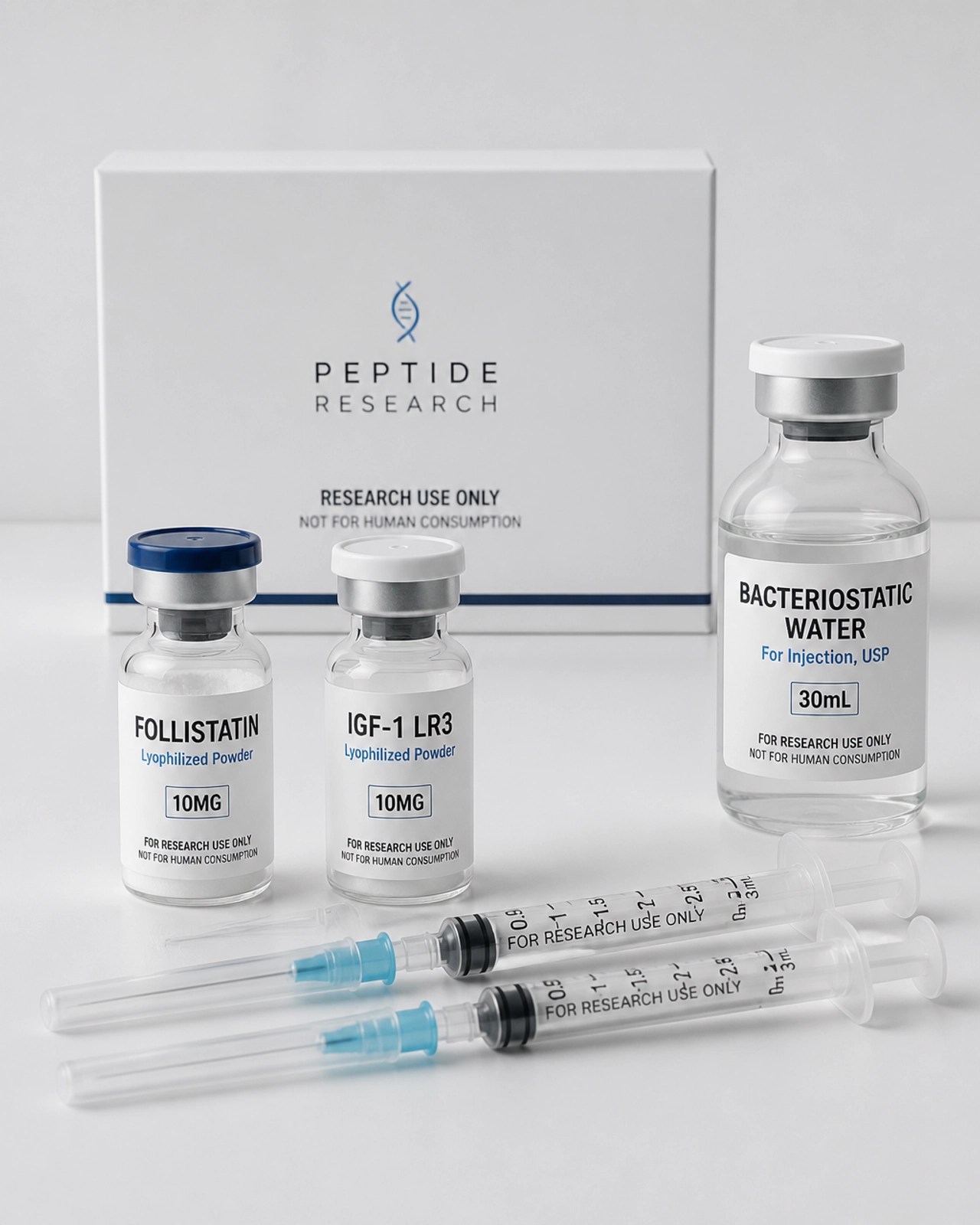 Clean, minimalist photography of a peptide research kit including vials of Follistatin and IGF-1 LR3