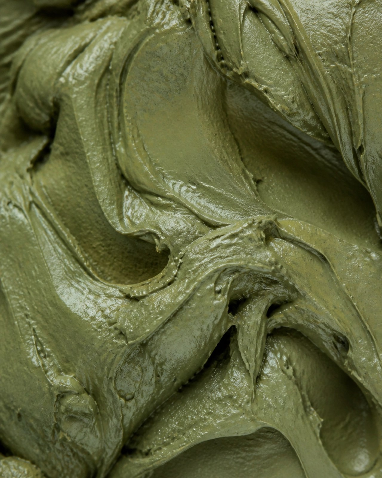 Close-up texture of moist green healing clay