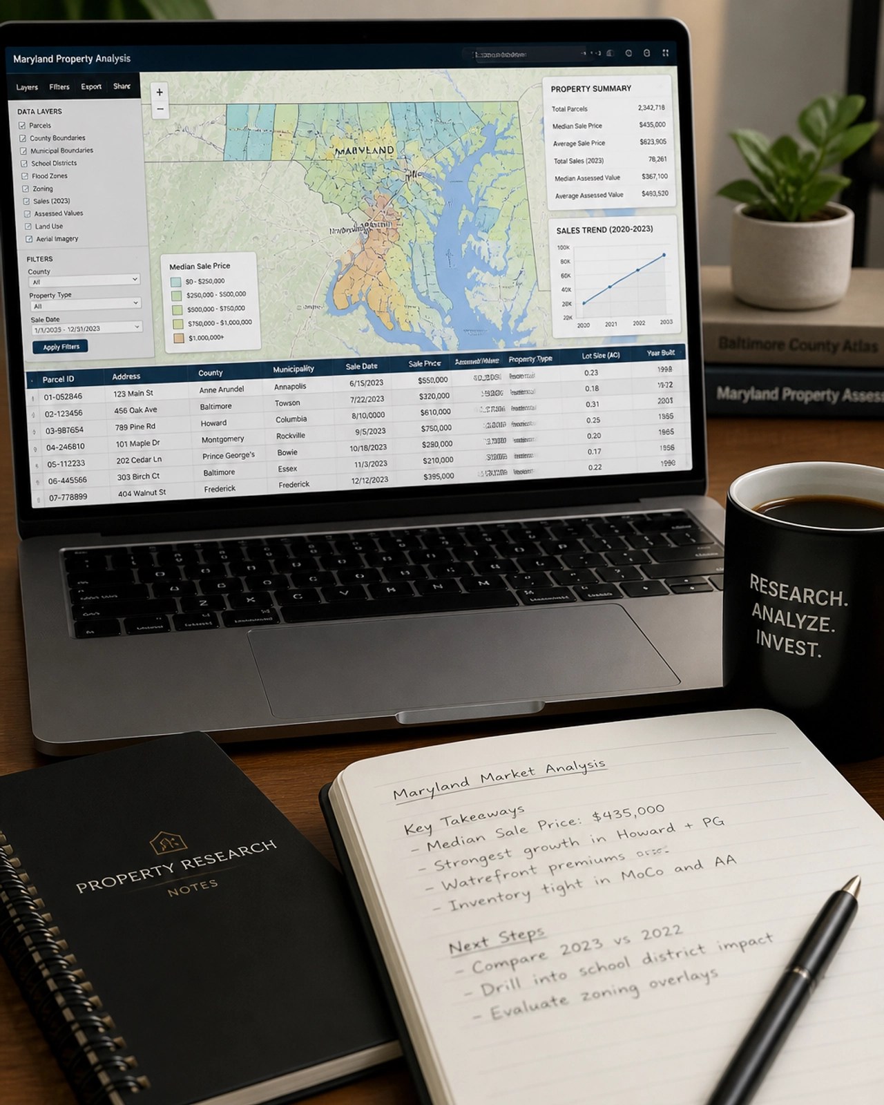 A laptop screen displaying property data maps and spreadsheets for research