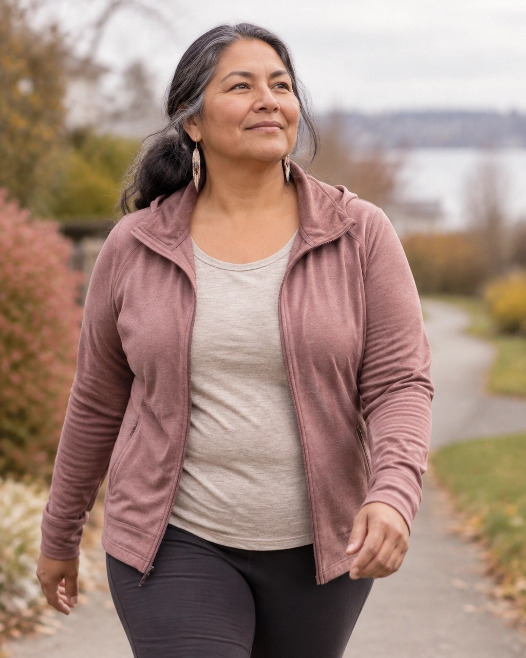 Indigenous woman over 50 taking a gentle neighborhood walk as a sustainable wellness step
