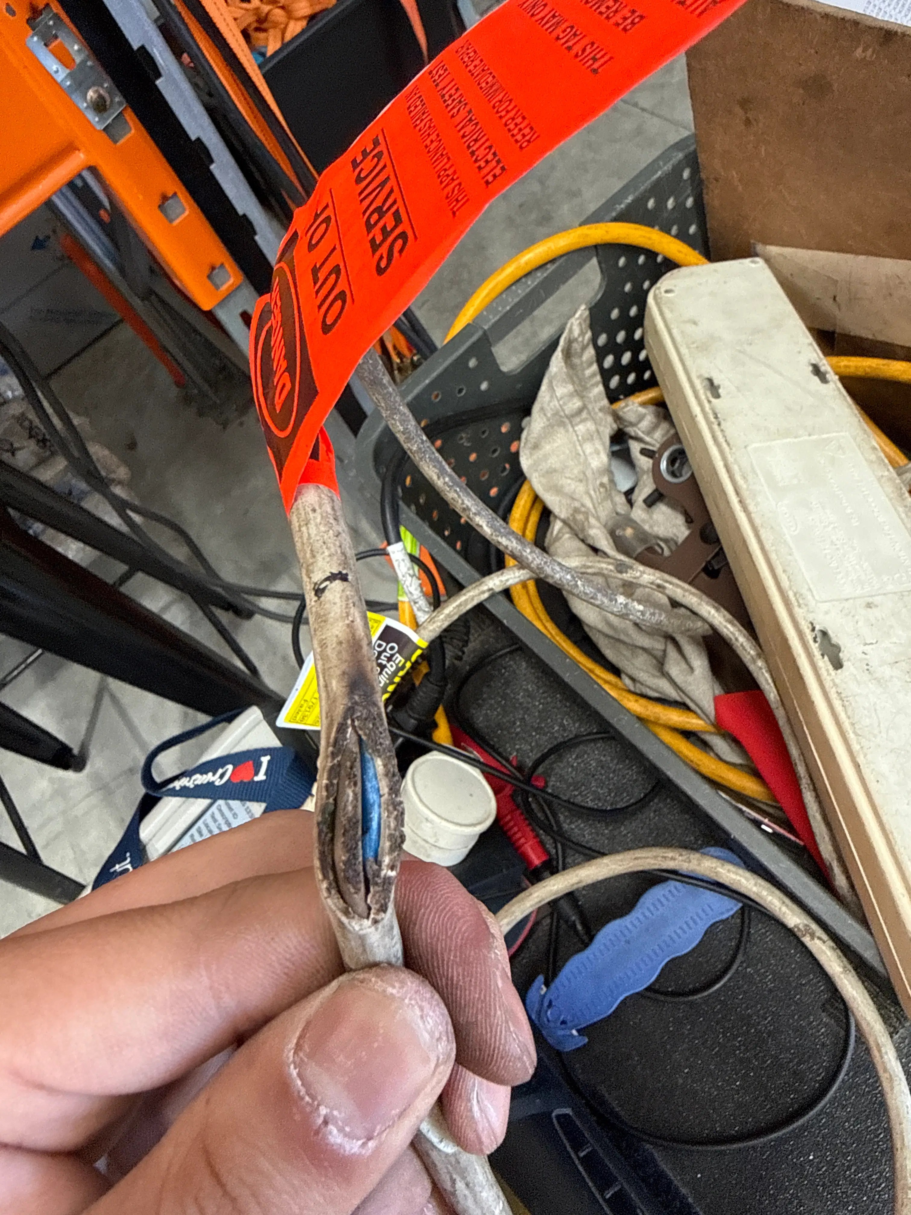Charred electrical cable tagged out of service after hazard identification in a Newstead workplace