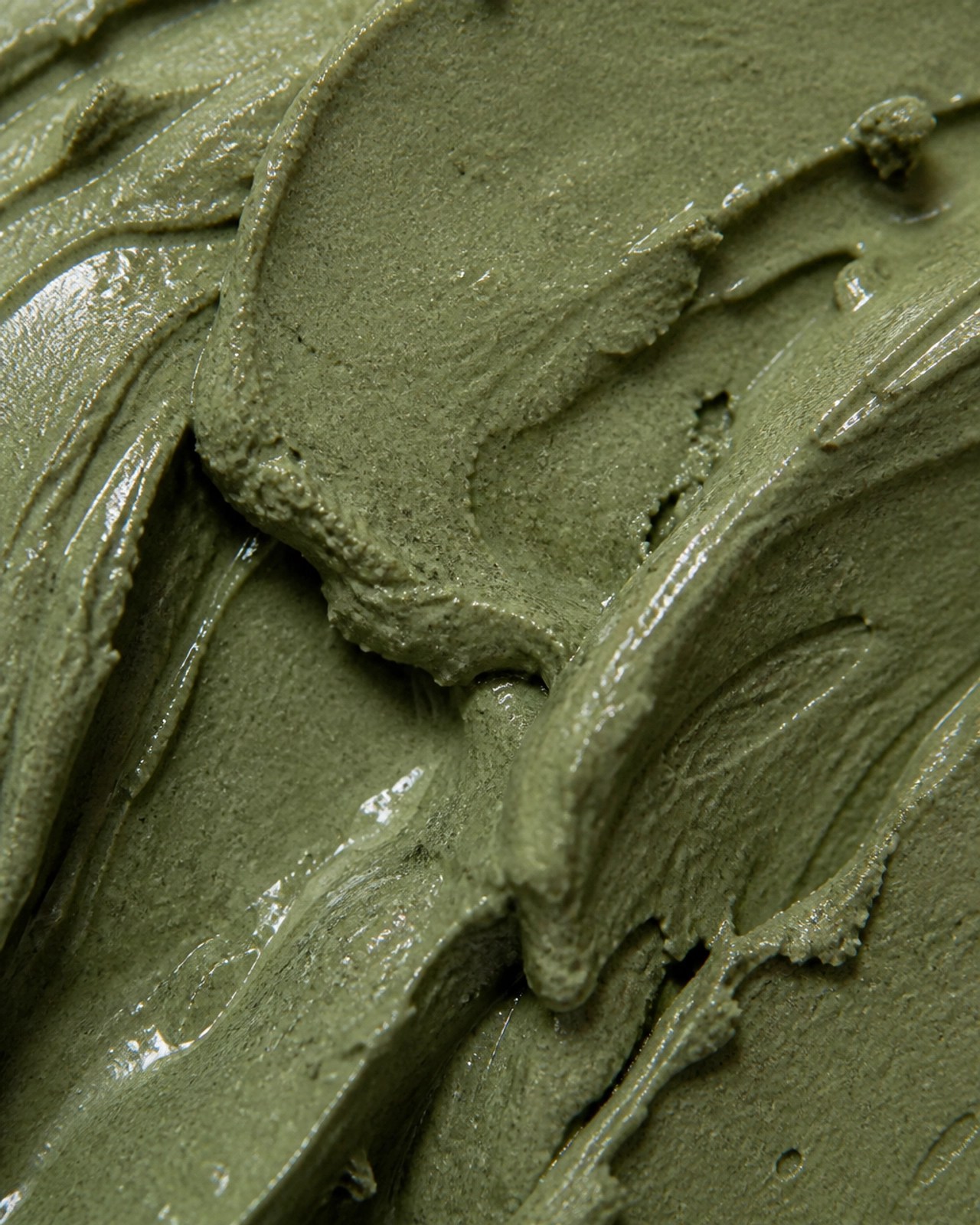 Close-up of rich, mineral-dense French green clay texture