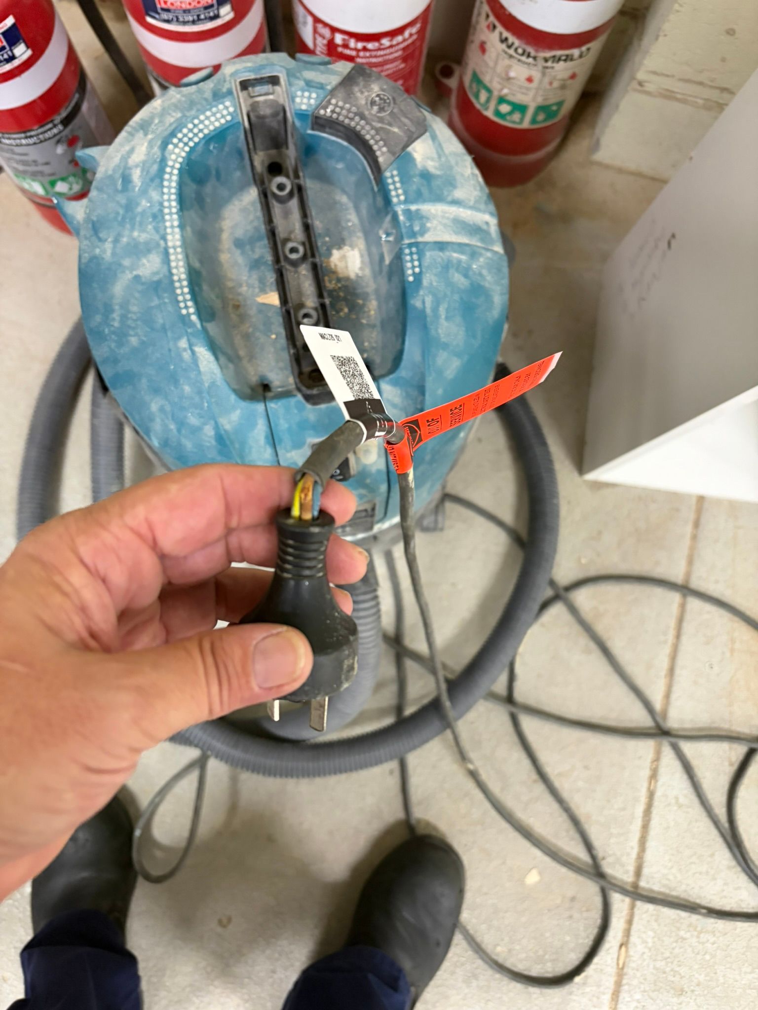 Damaged electrical plug marked out of service after failing inspection and testing
