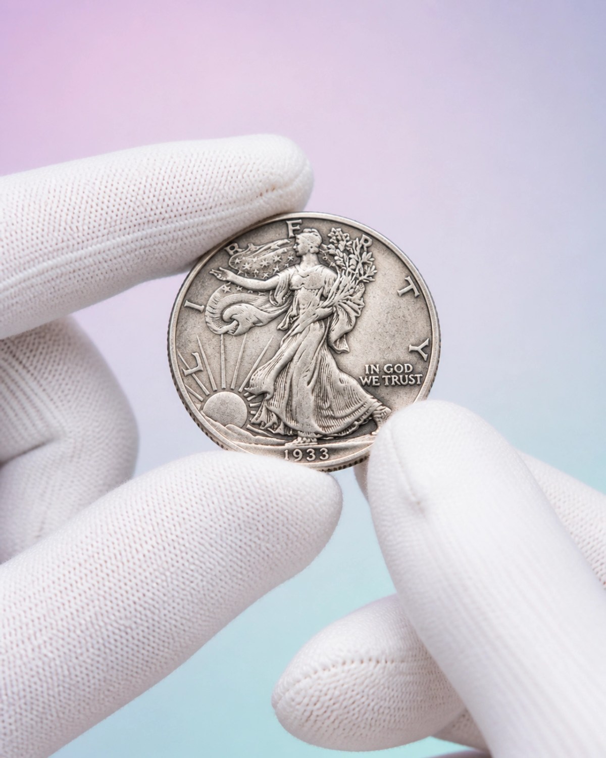 White cotton gloves holding a silver coin by the edges to show proper handling