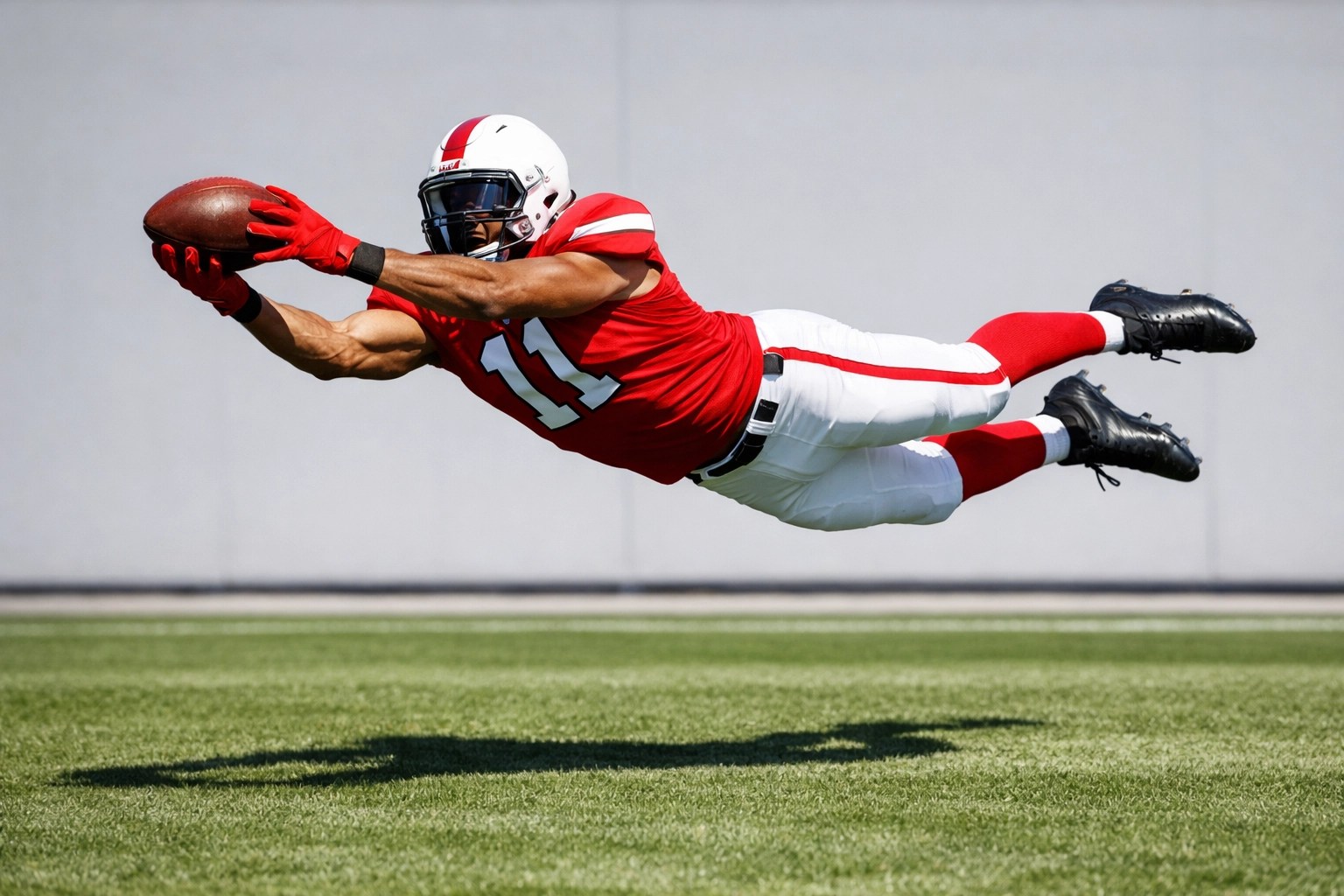 Atlanta football wide receiver making a catch during positional training.