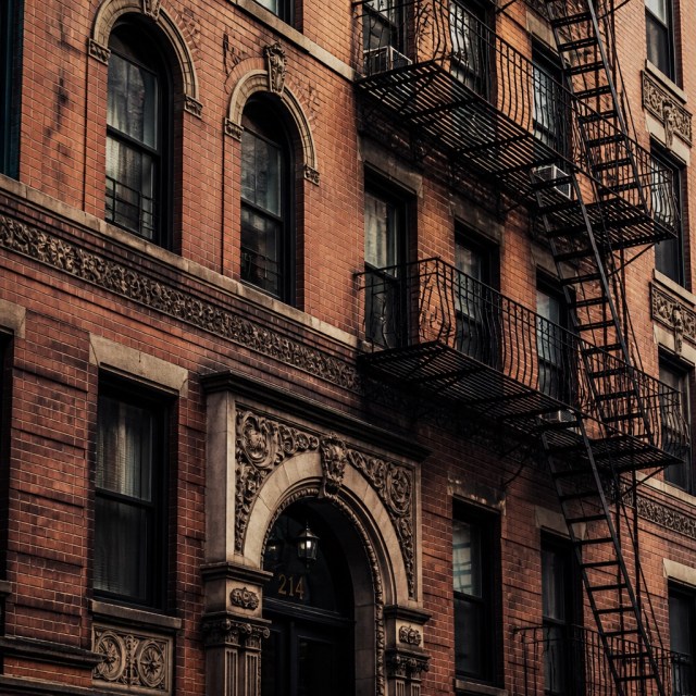 Intricate brickwork of a pre-war Manhattan apartment building, a staple of the city's rent-stabilized inventory.