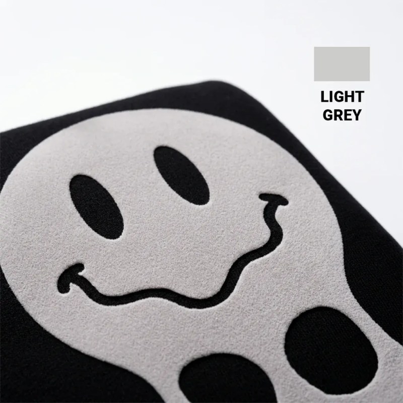 Close-up of a raised puff-print graphic on black apparel demonstrating a dimensional specialty print