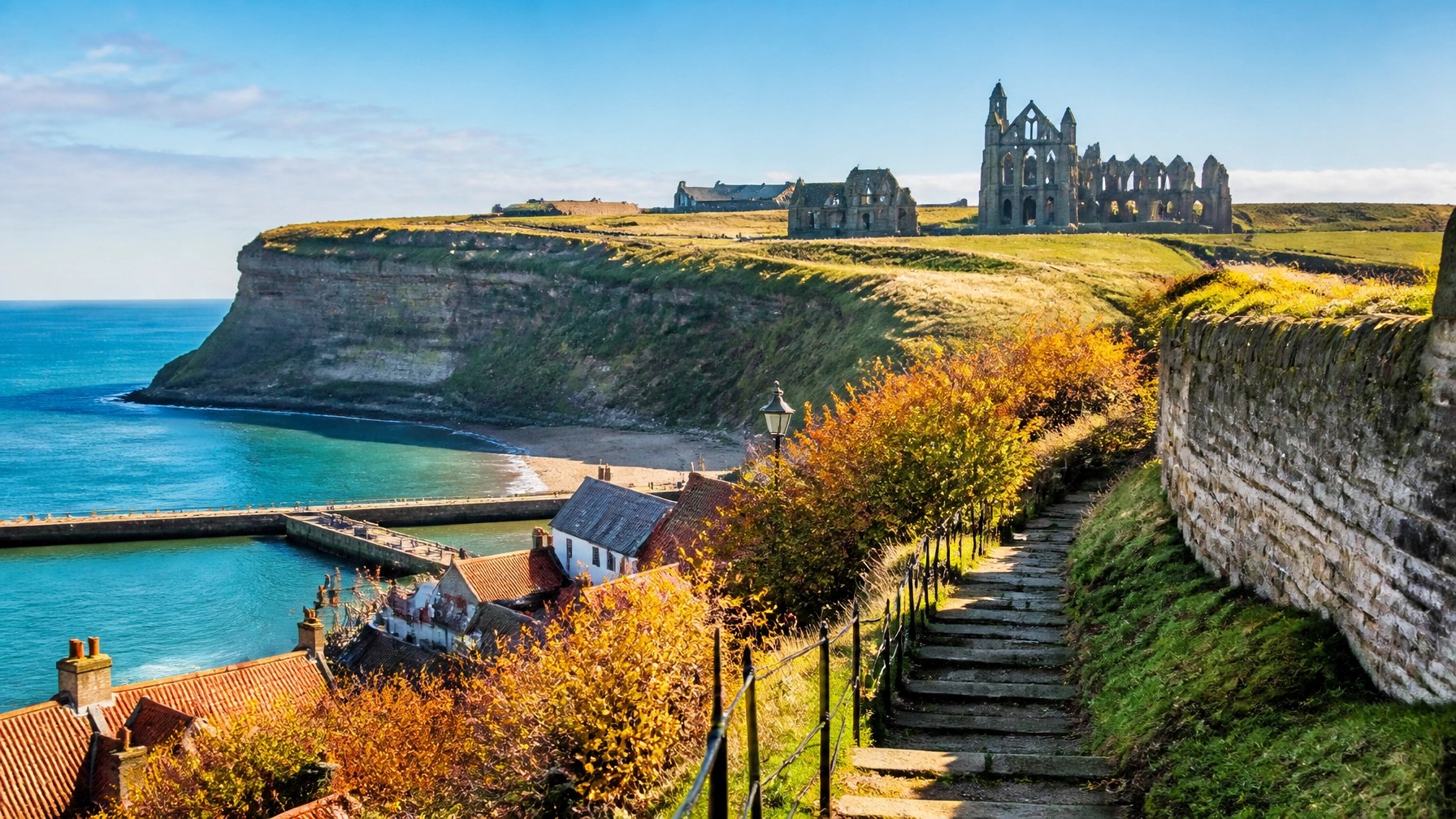 Whitby Abbey standing above the Yorkshire coast in bright autumn daylight